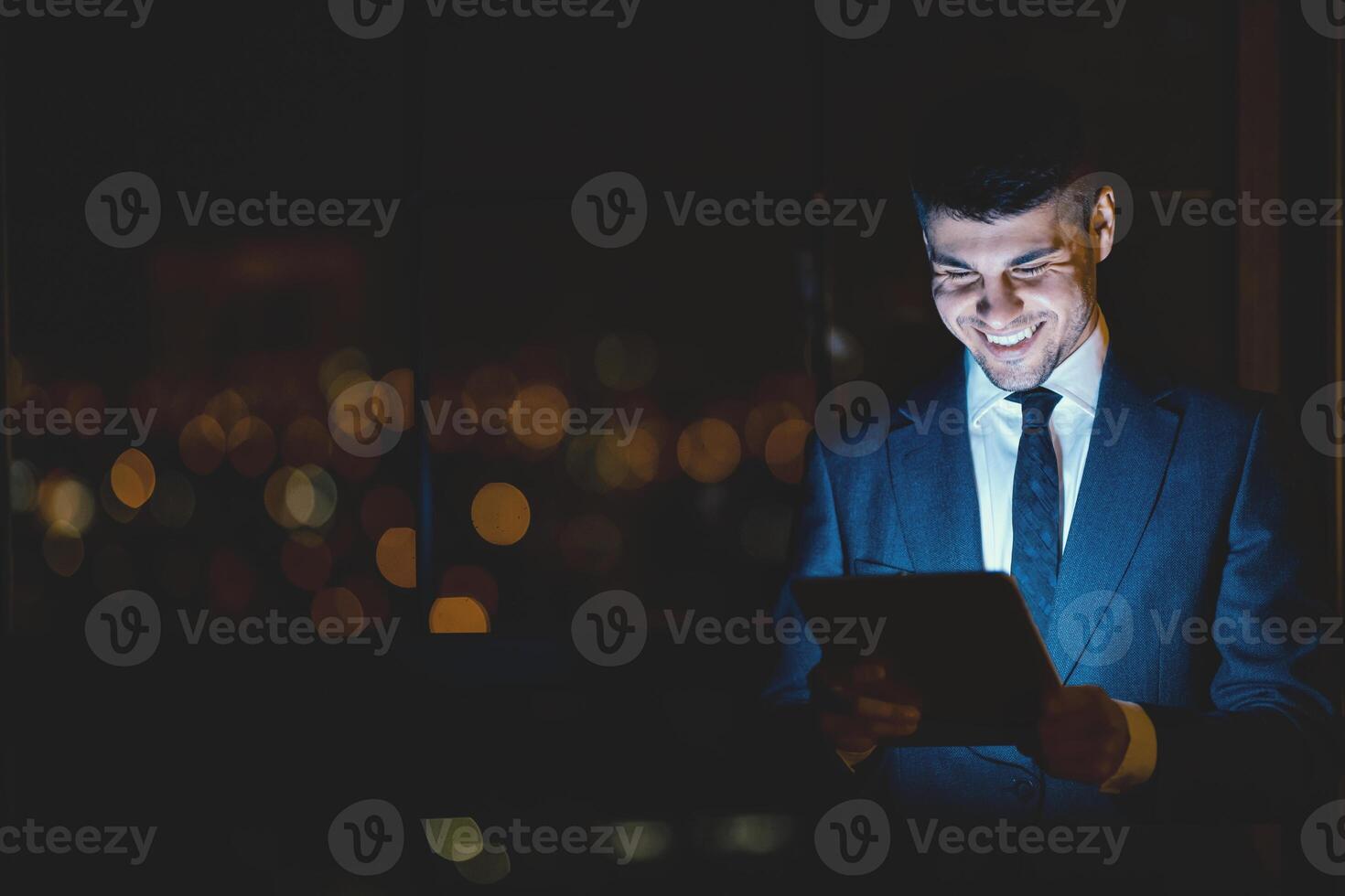 Great Business News. Happy Businessman Using Tablet Computer Browsing Internet At Work Standing In Modern Office. Copy Space photo