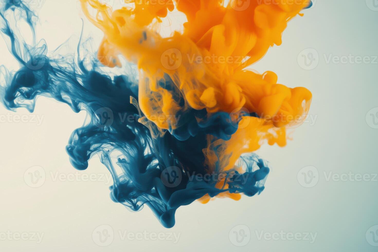 Colorful swirls of orange and blue ink blending in water, creating captivating abstract art photo