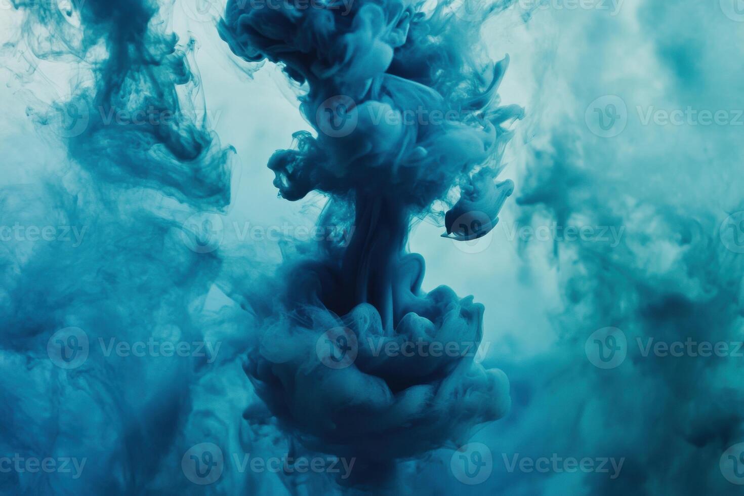 Swirling blue ink cloud underwater creating mesmerizing patterns and textures in tranquil waters photo