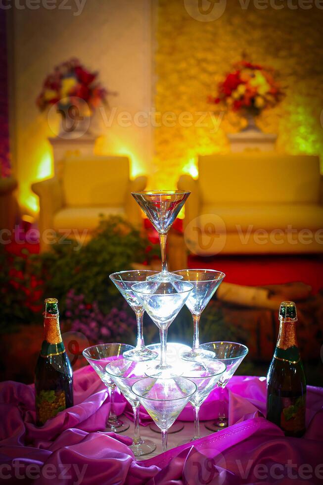 A table with a bunch of wine glasses and champagne bottles photo
