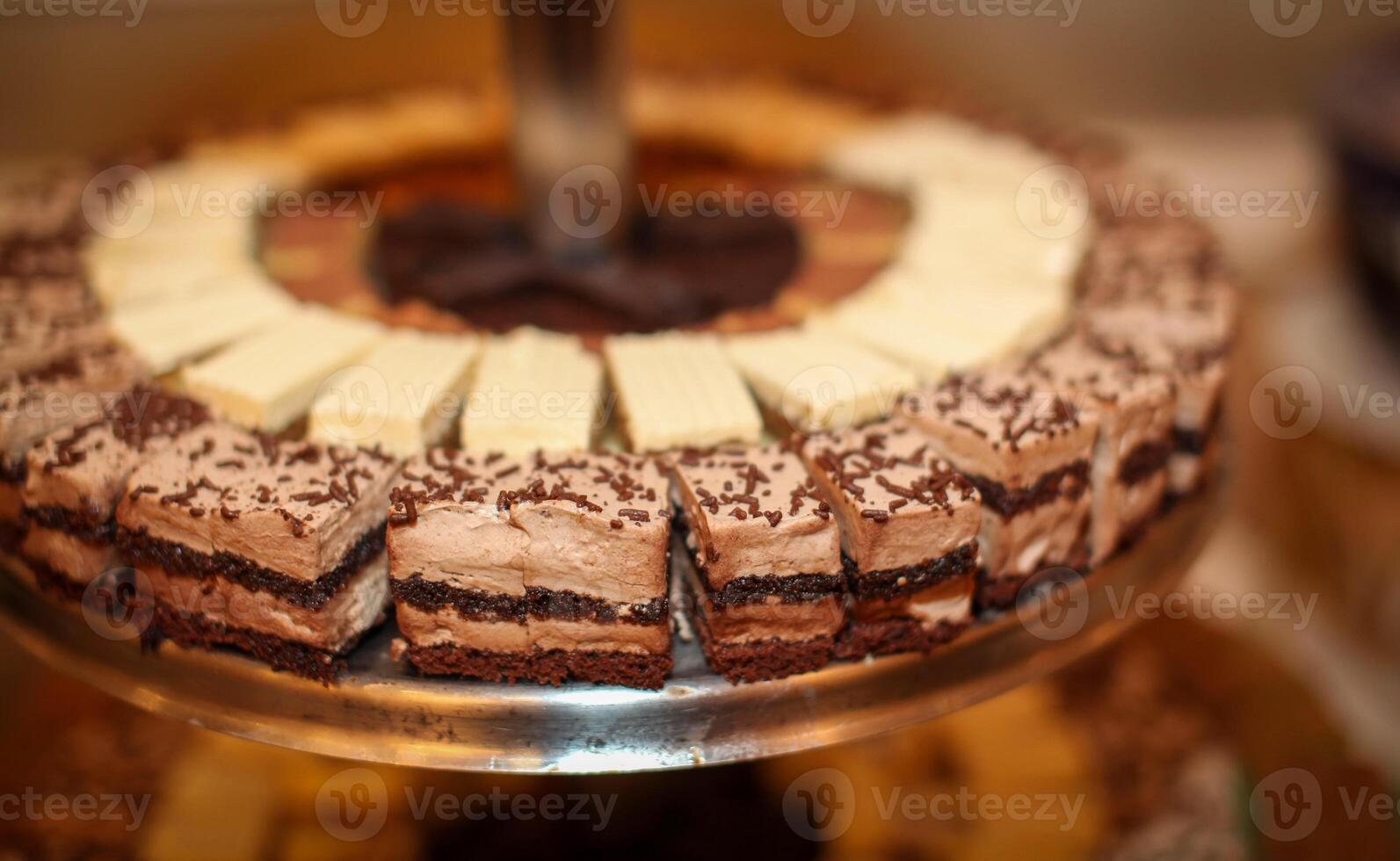 Beautiful multicolored decorated baked sweet tasty party cakes or catering cakes for party, bar dessert selection with cake, pie and pastries catering banquet, coffee break buffet at a conference photo