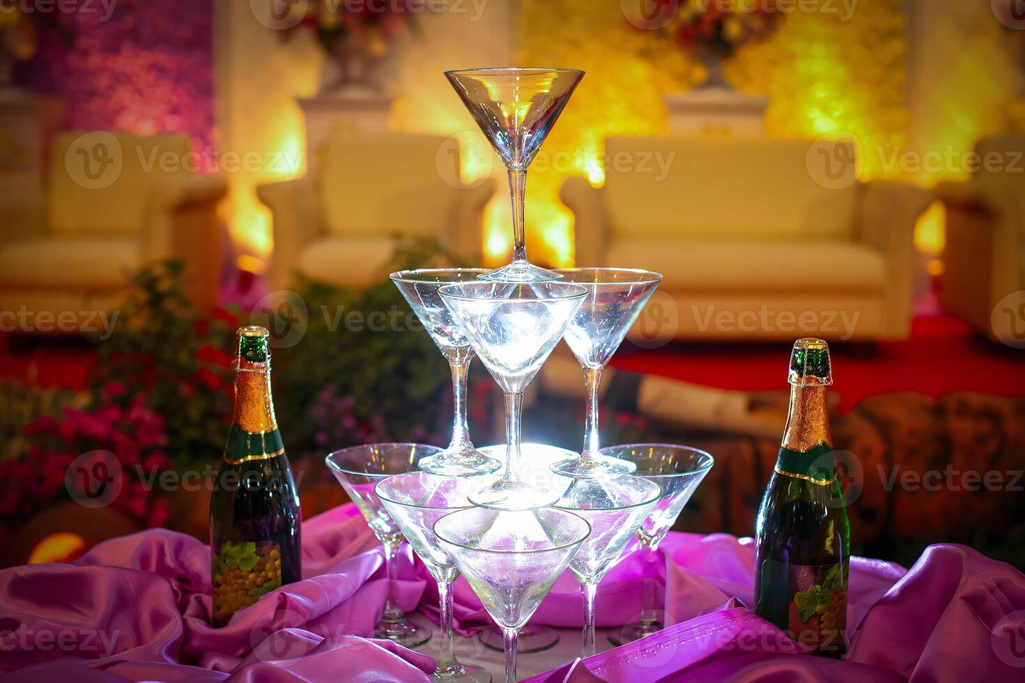 A table with a bunch of wine glasses and champagne bottles photo