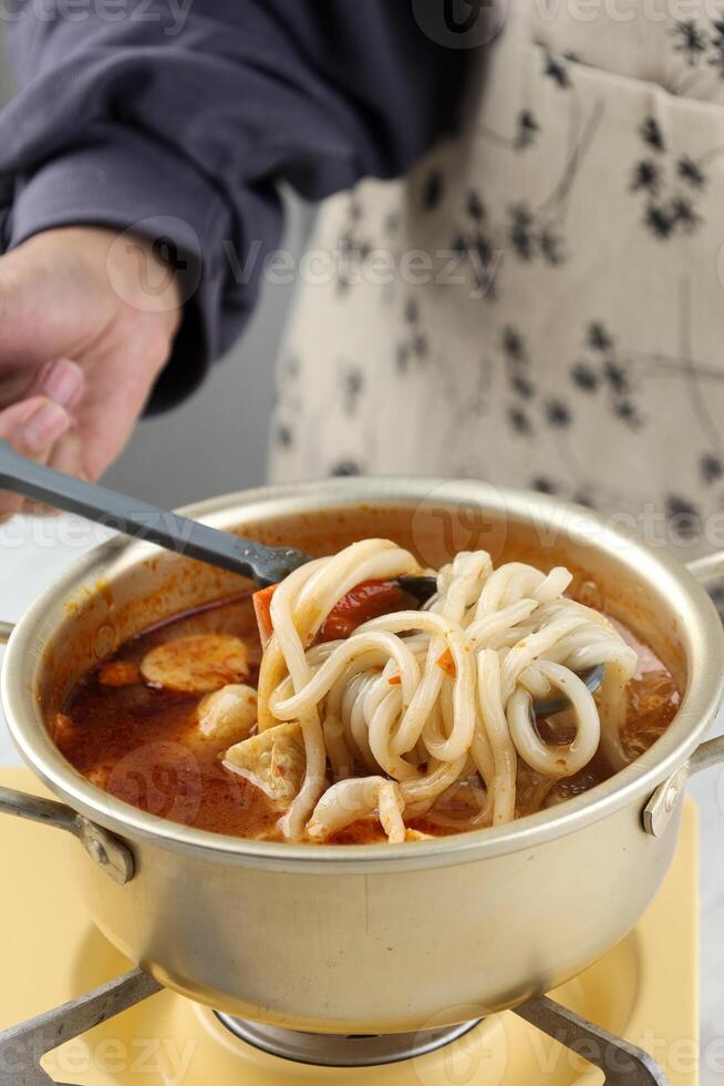 Close Up Boiling Udon on Spicy Sauce photo