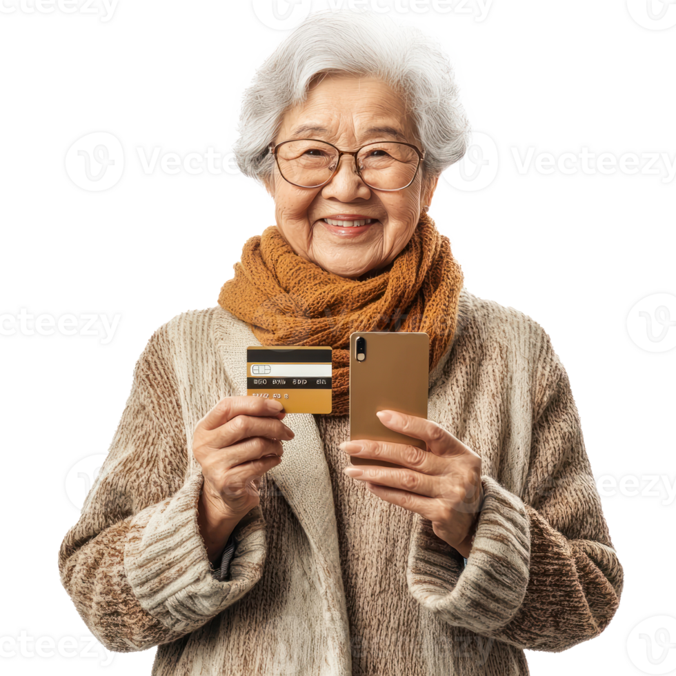 Smiling senior woman holding holding a credit card and a mobile phone, standing front view isolate on transparent background png