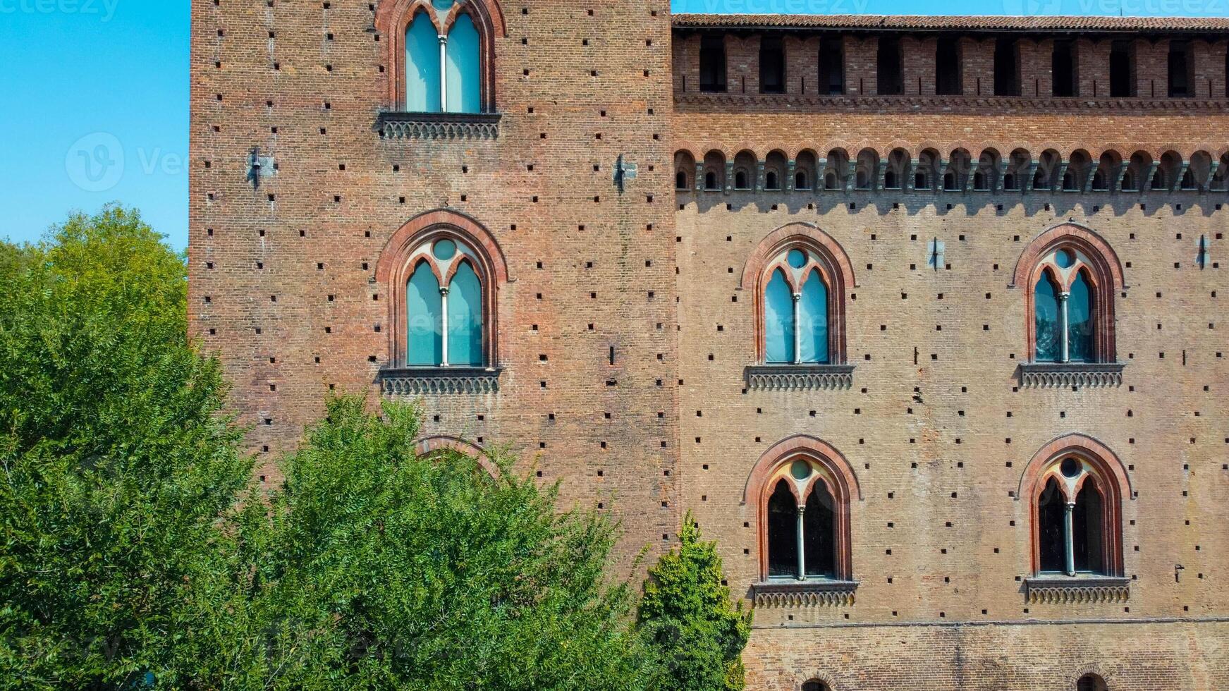 Italian castle an artistic historical cultural heritage. Visconti castle of Pavia with its walls, bridge, moat, towers. Structure that attracts tourists traveling to discover the wonders of Italy. photo