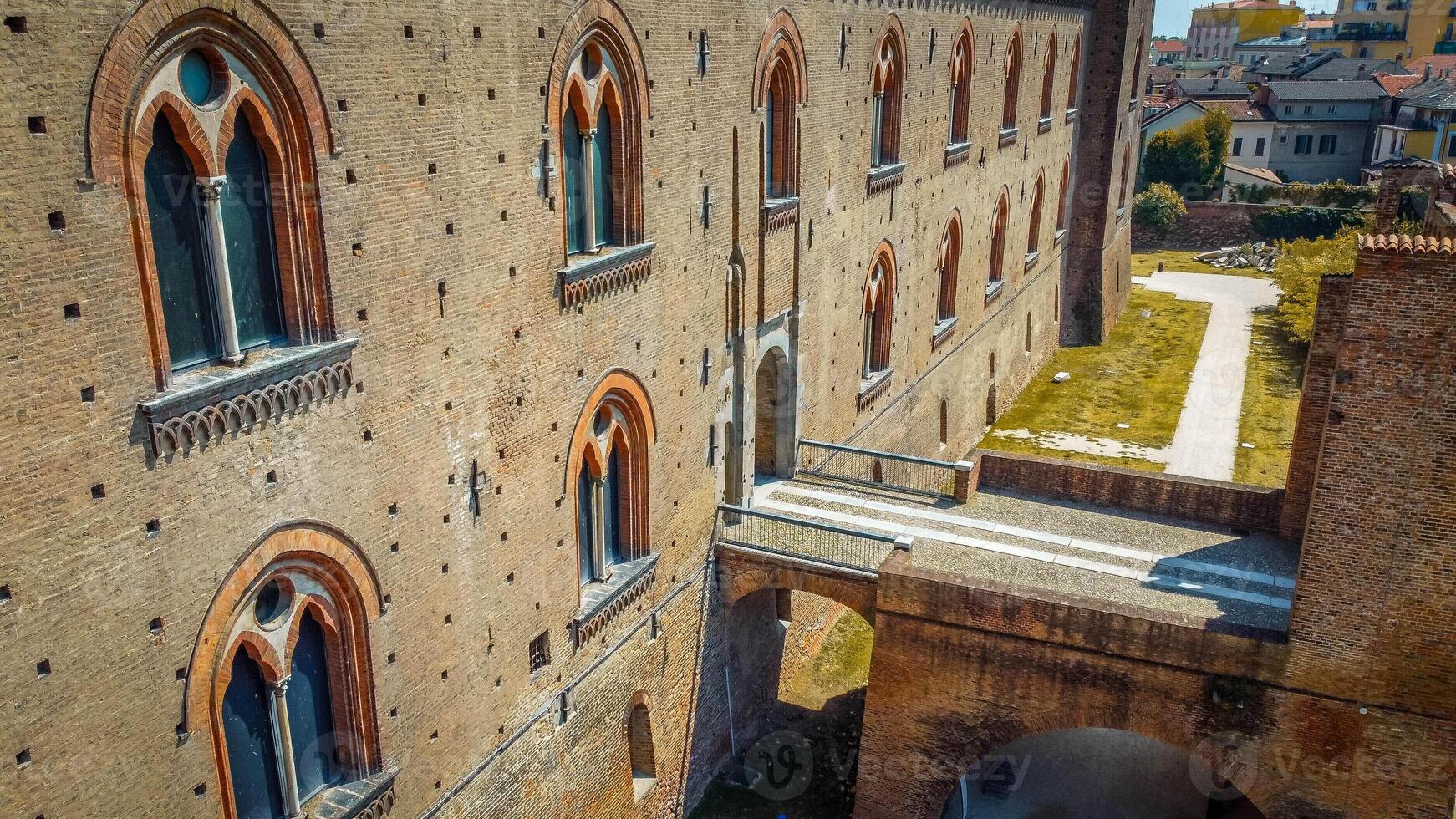 Italian castle an artistic historical cultural heritage. Visconti castle of Pavia with its walls, bridge, moat, towers. Structure that attracts tourists traveling to discover the wonders of Italy. photo