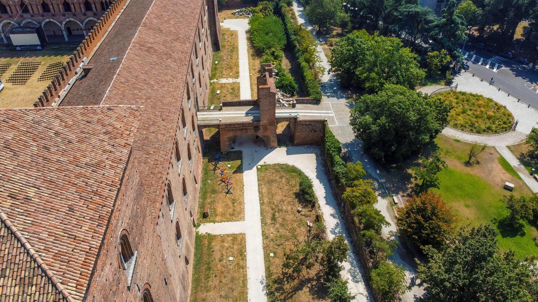 Italian castle an artistic historical cultural heritage. Visconti castle of Pavia with its walls, bridge, moat, towers. Structure that attracts tourists traveling to discover the wonders of Italy. photo