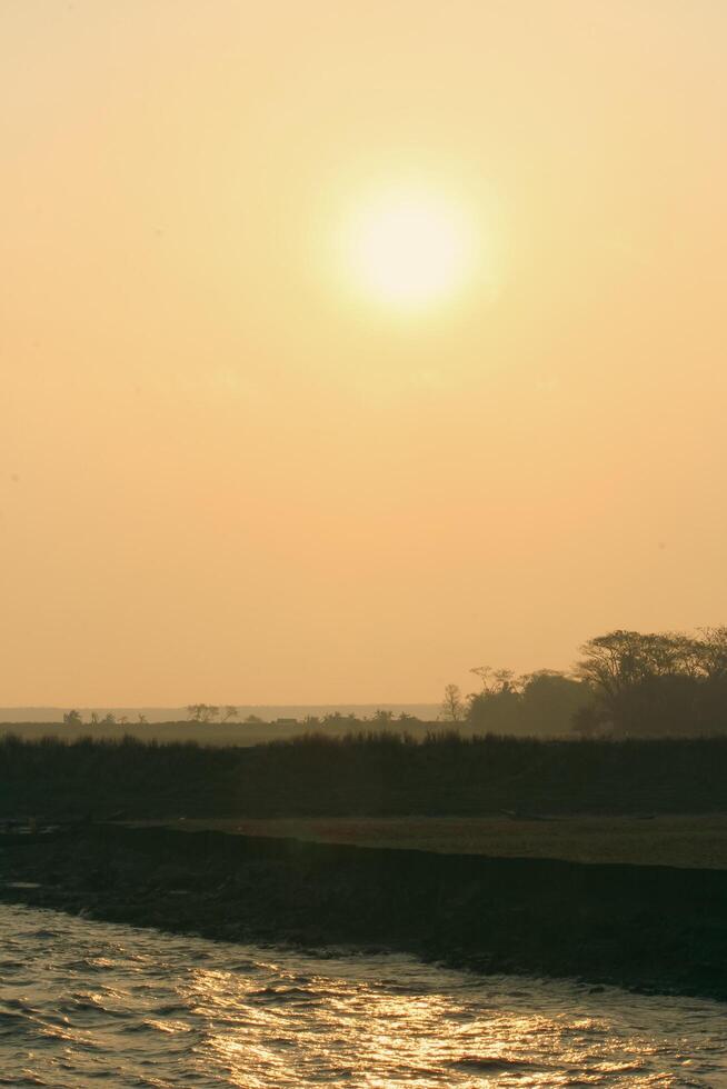 Beautiful Sunrise Over Green Fields on Monpura Dwip photo