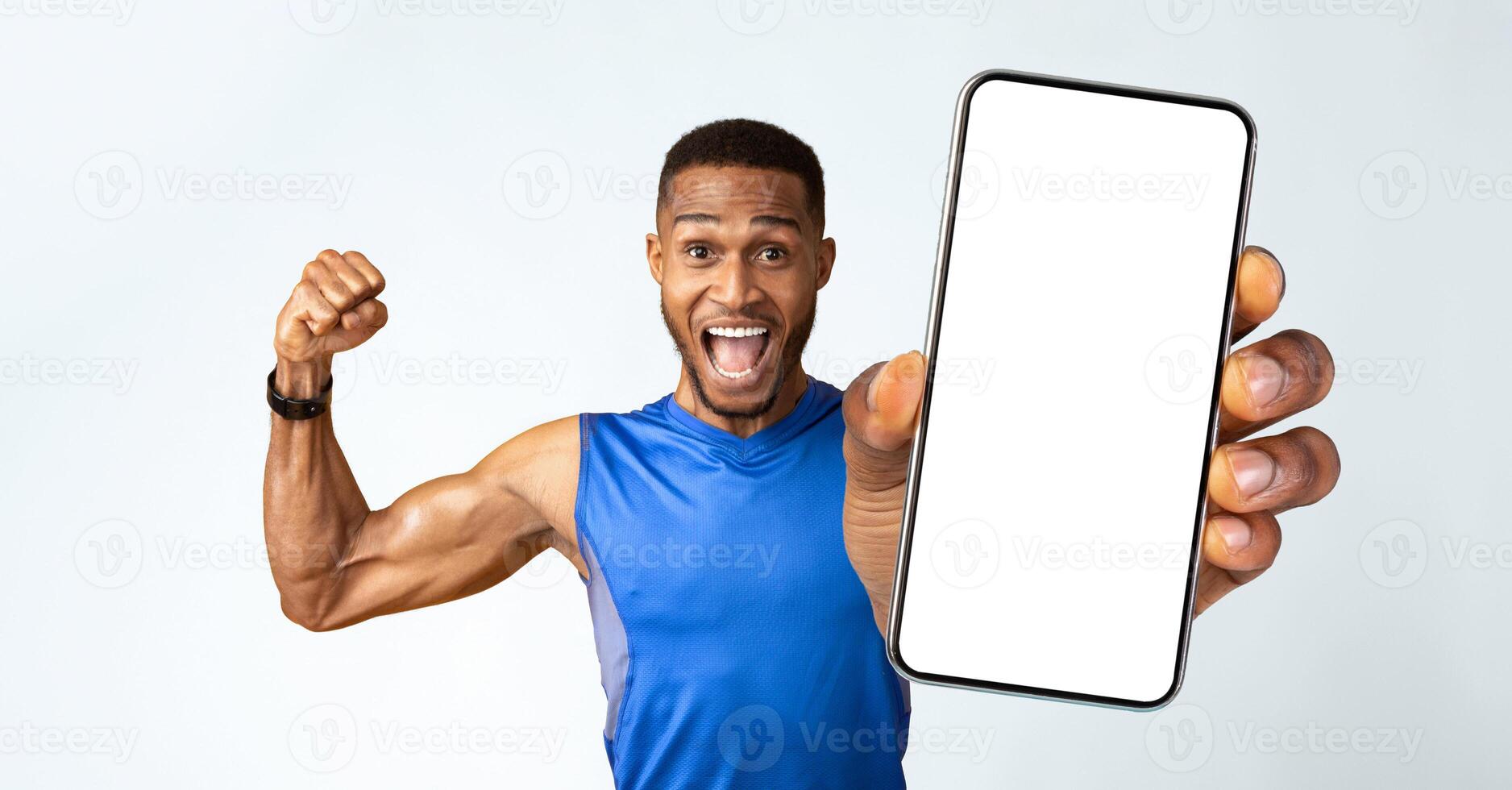 Winner. Excited black sportsman celebrating triumph, raising clenched fists in the air isolated yellow studio background photo