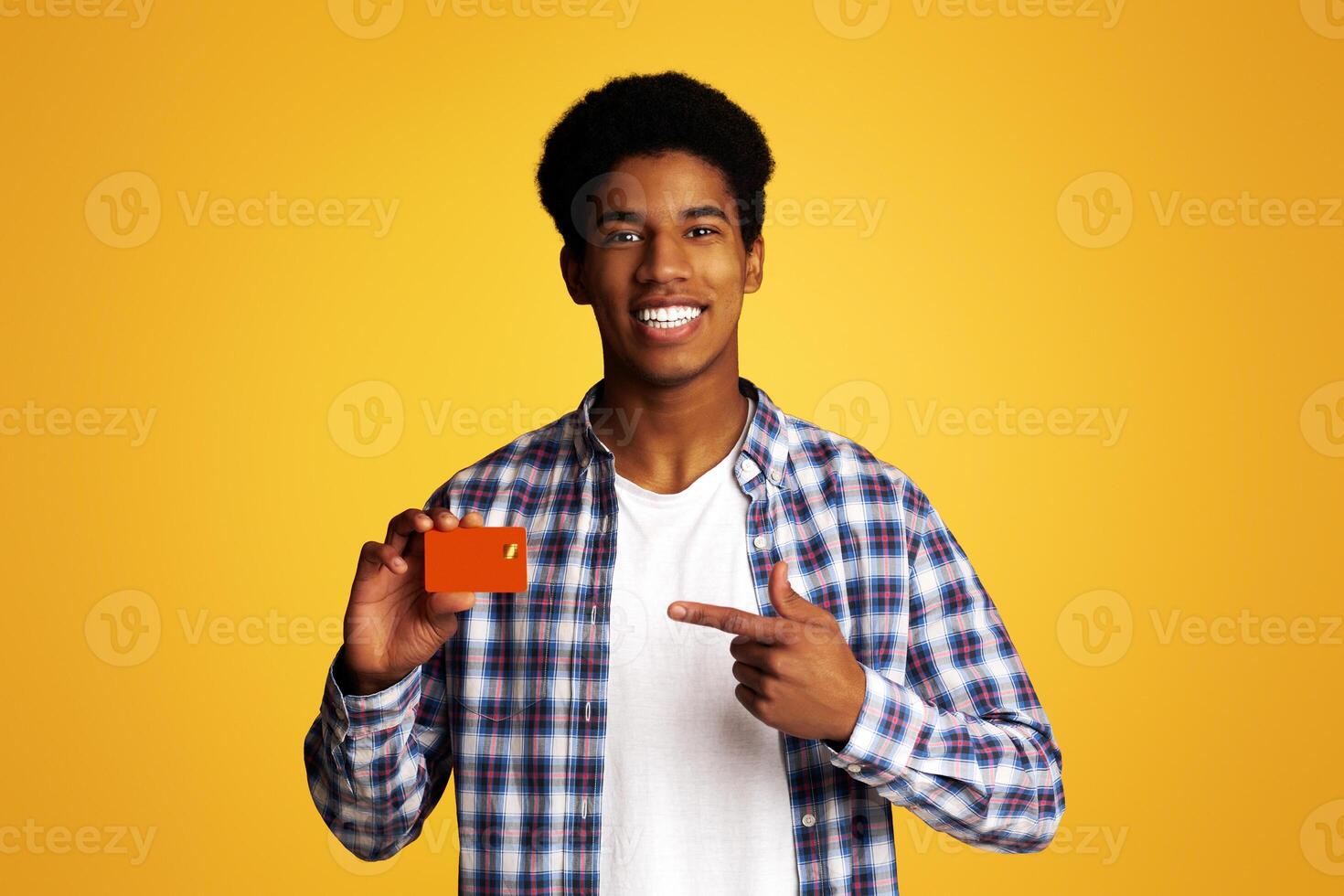 Happy Guy Holding Credit Card and Point on It, Peased Cient Demonstrating Bank Product photo