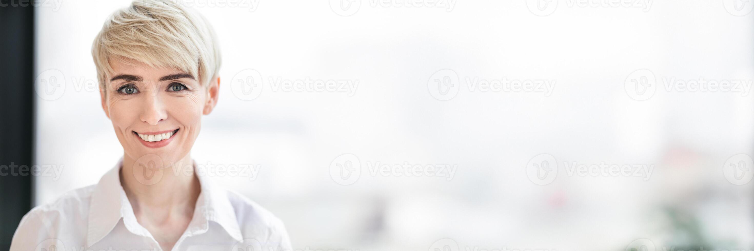 Businesswoman. Portrait Of Successful Mature Business Lady Smiling Looking At Camera Posing Near Window In Modern Office. Selective Focus, Copy Space photo
