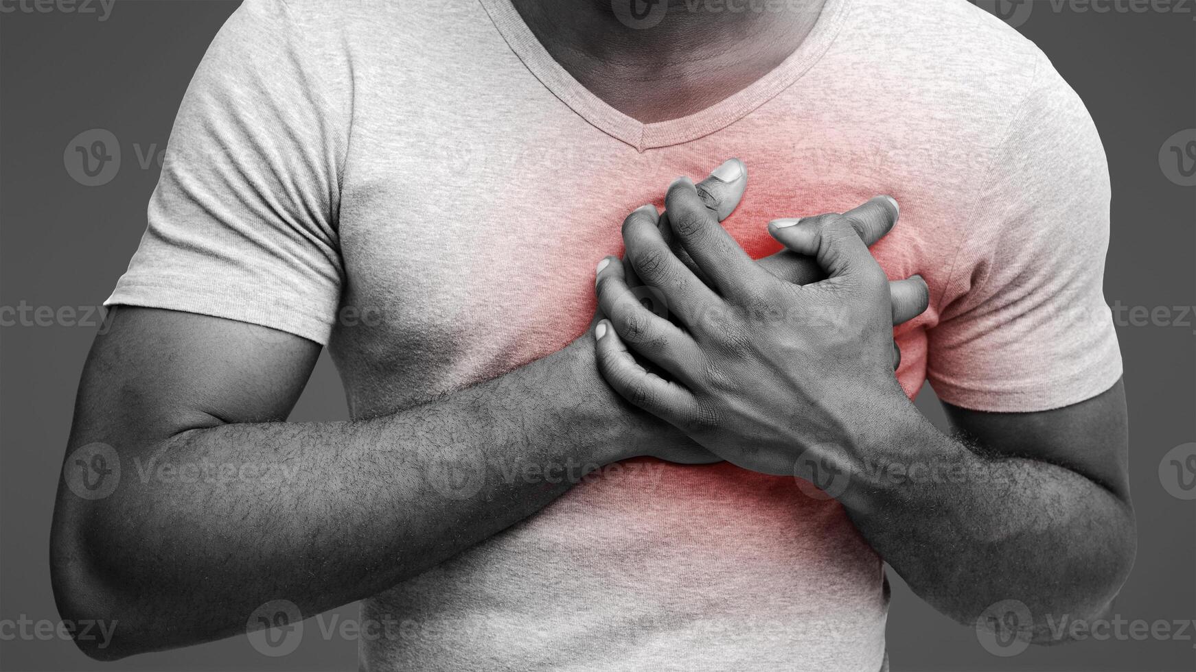 Young afro man having heart ache, holding hand on chest. Heart attack or stroke, cropped photo