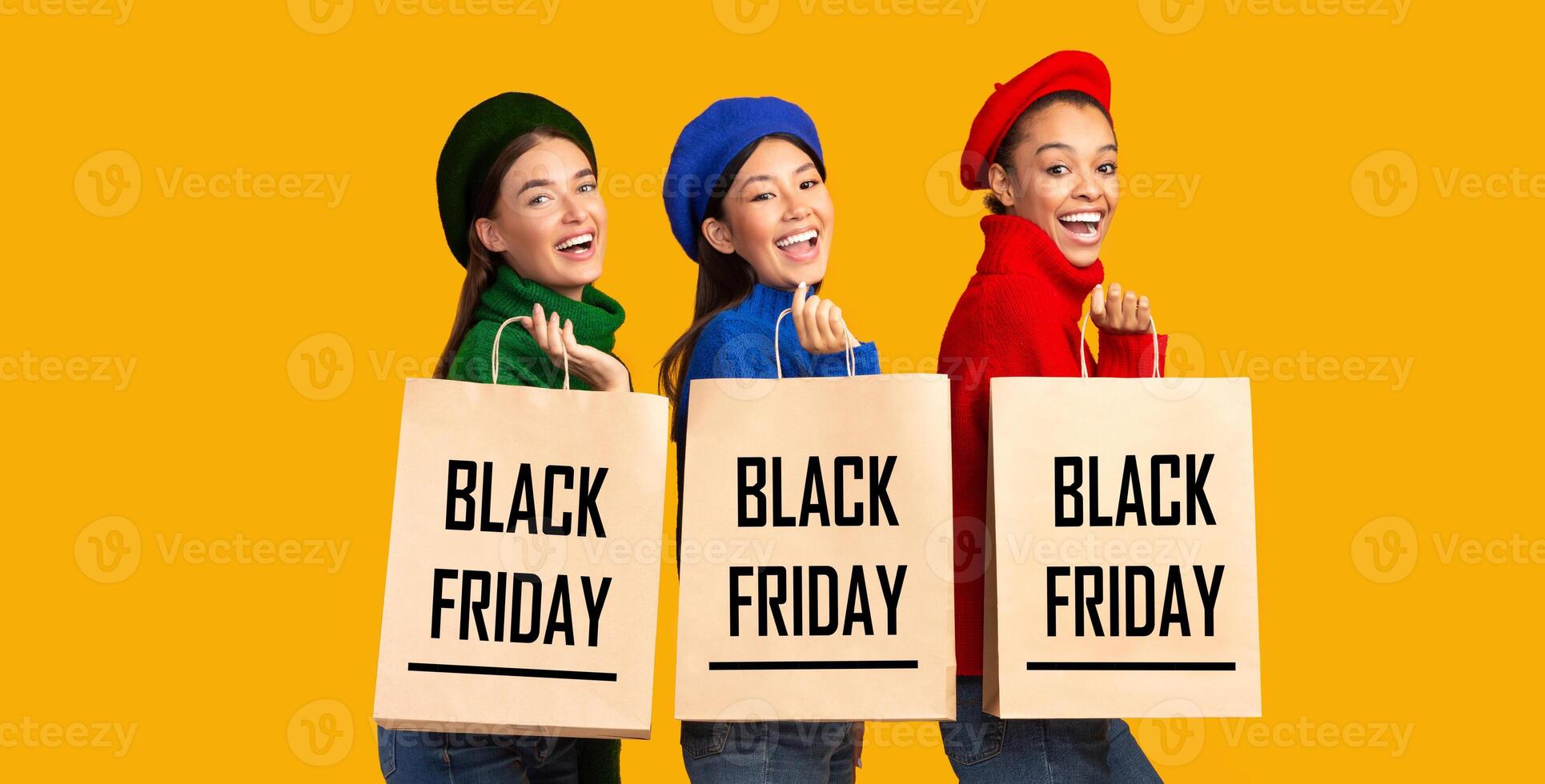 Three Multiethnic Women Holding Shopping Bags With Black Friday Text Announcing Sales Standing On Yellow Background. Copy Space, Panorama photo