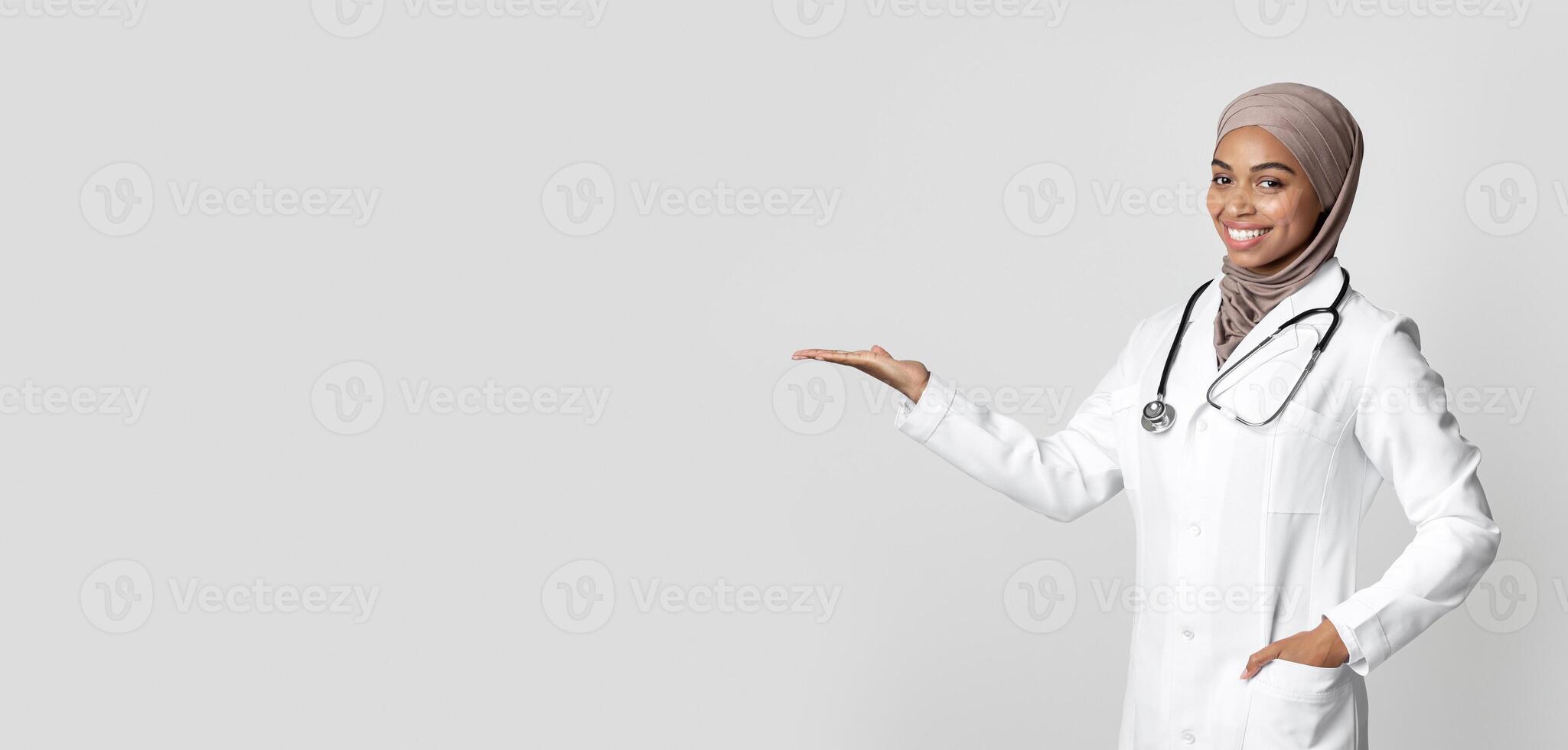 Effective Flu Remedy. Young Black Female Doctor Holding Invisible Item On Her Palm, Showing New Vitamin Complex, Demonstrating Pack With Medicine photo