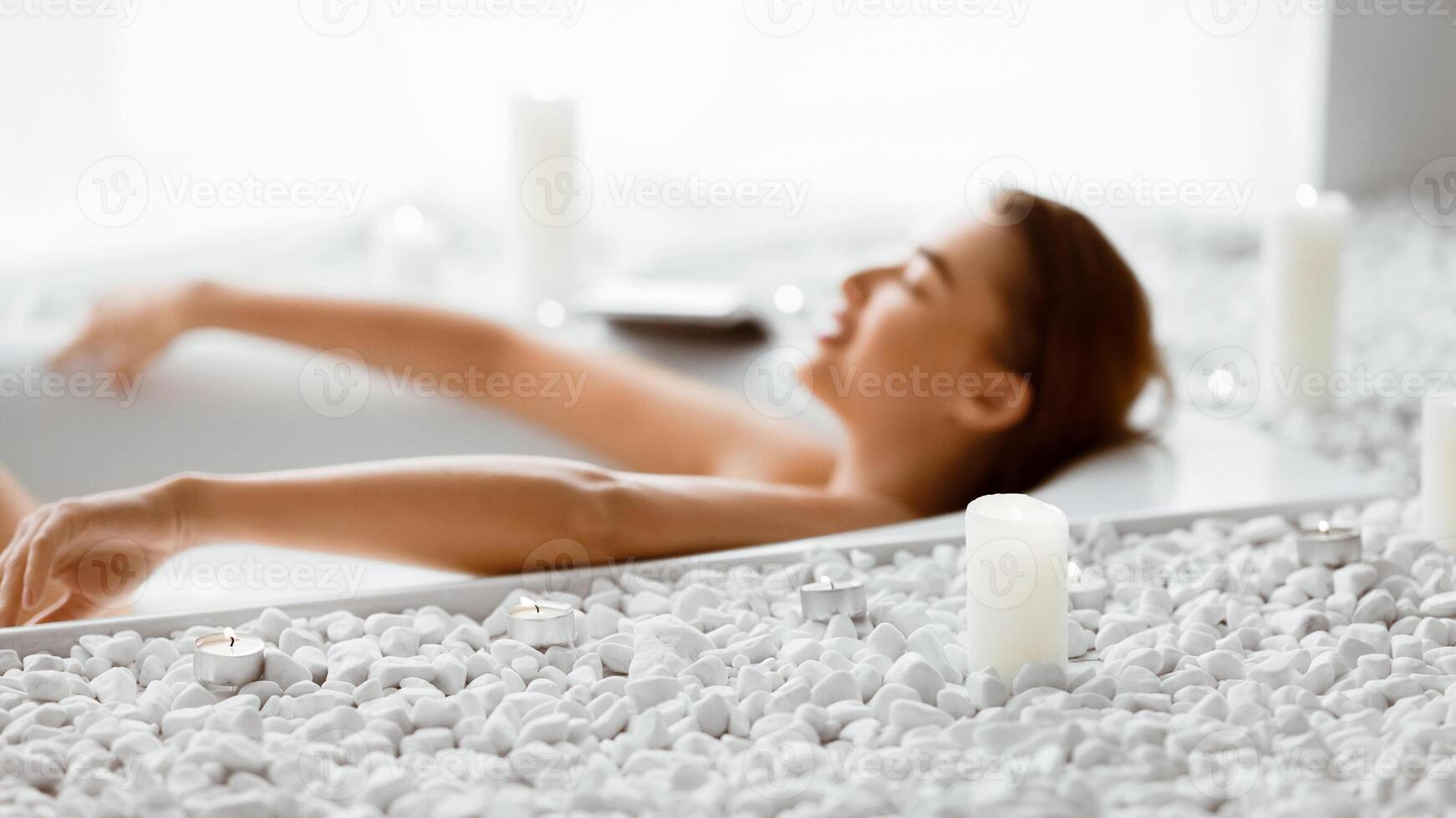 Enjoy Spa Procedure. Woman Lying In Bath With Foam And Candles photo