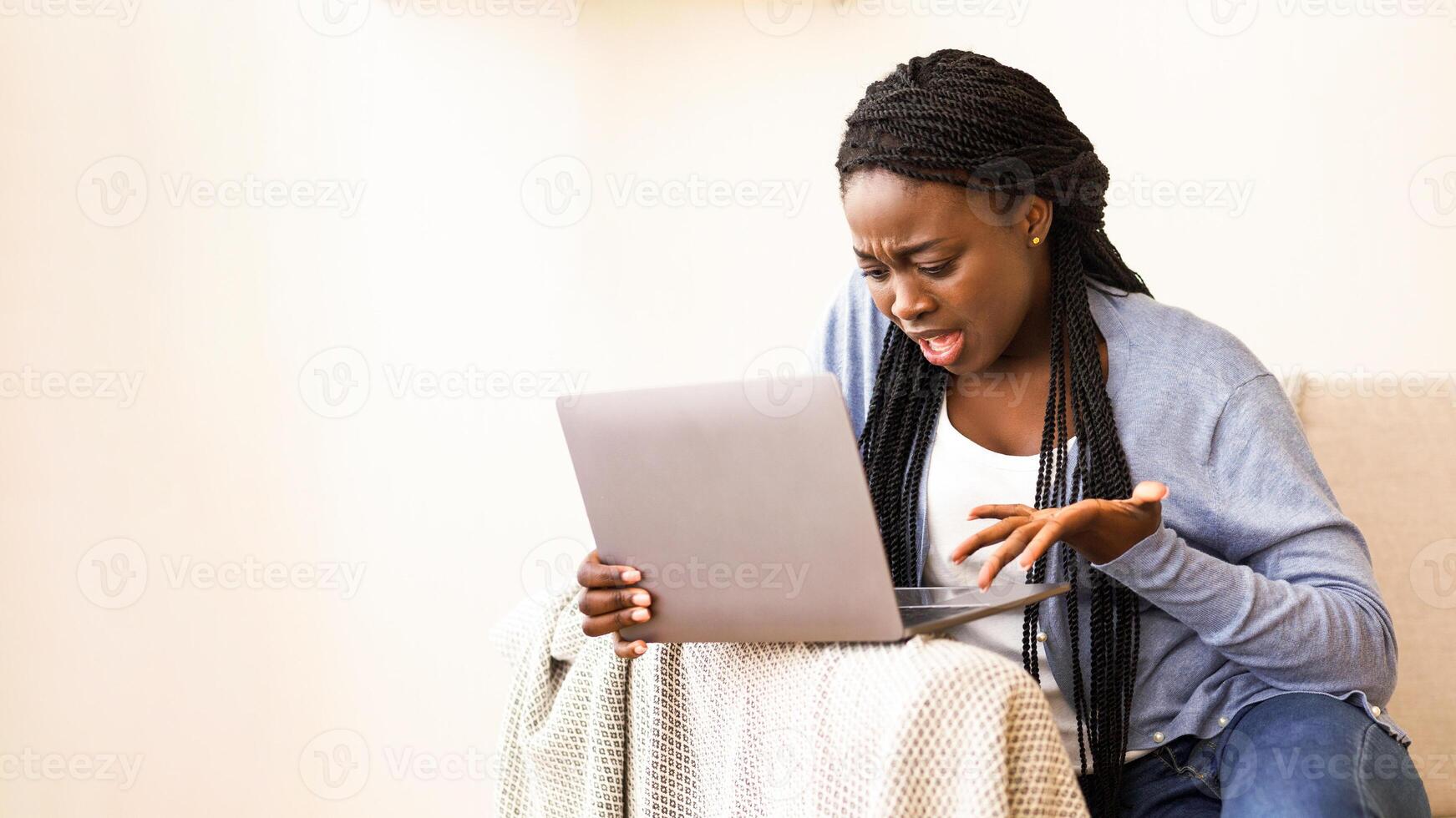 Computer problems. Frustrated african american woman having issues with laptop at home, disappointed with bad internet connection, free space photo
