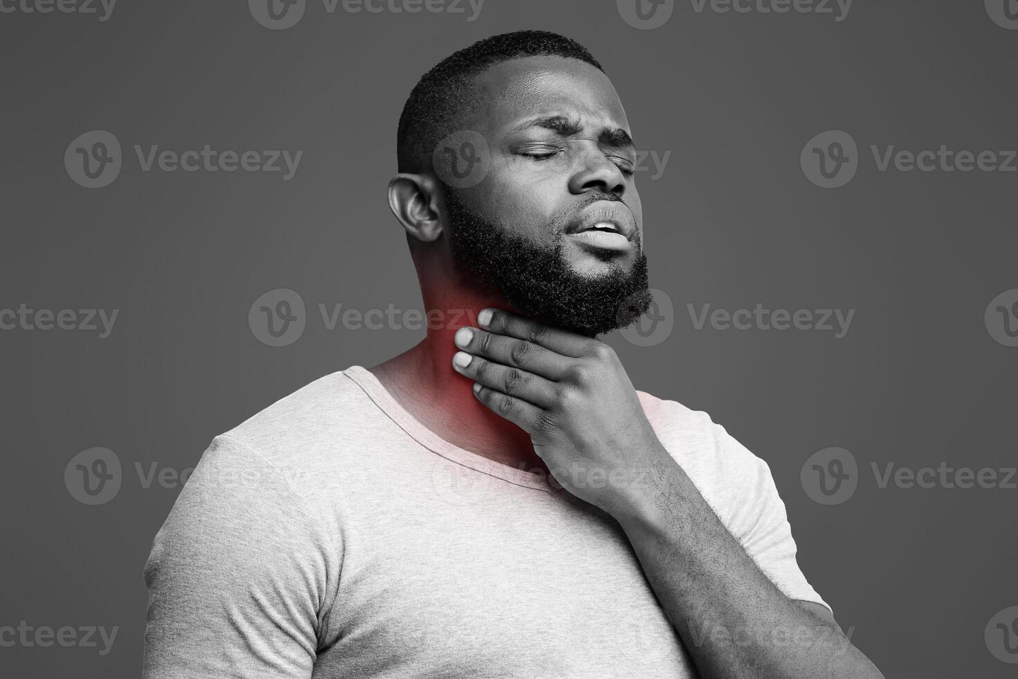Sad black guy suffering from sore throat, touching highlighted neck, copy space photo