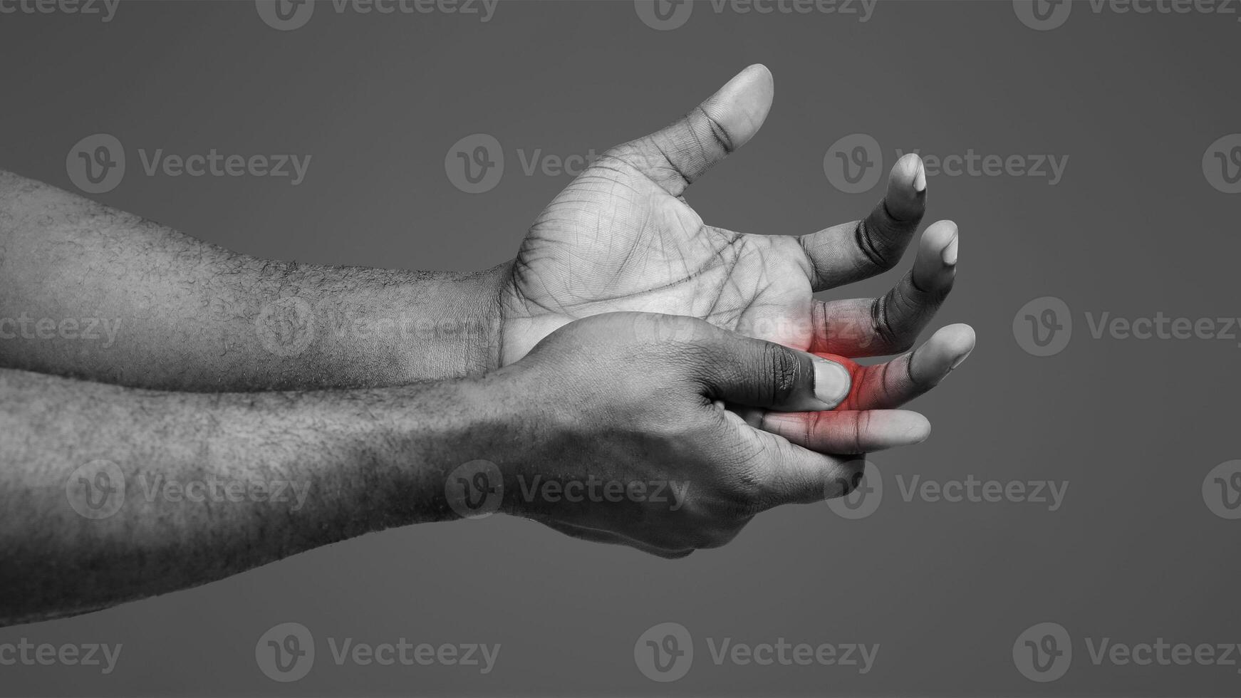 Cropped of man suffering from pain in hand and massaging his painful finger, white background photo