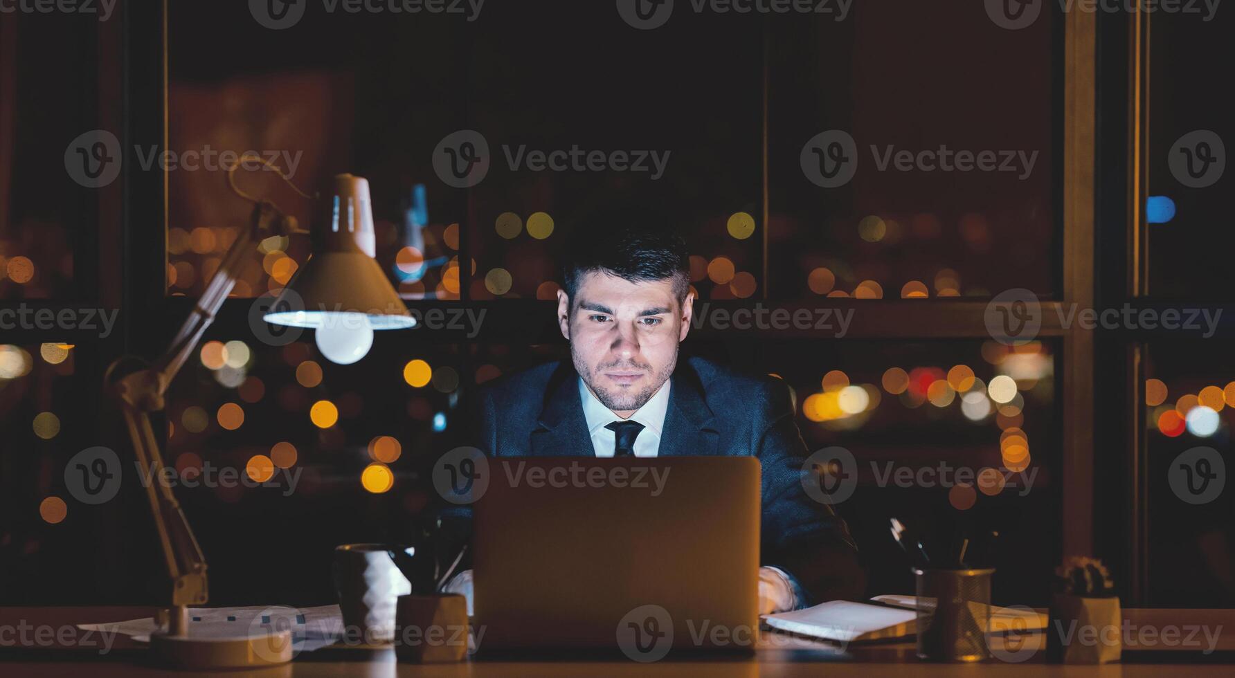 Businessman Working On Laptop At Night Sitting In Modern Office With Panoramic View. Business Career. Copy Space, Panorama photo