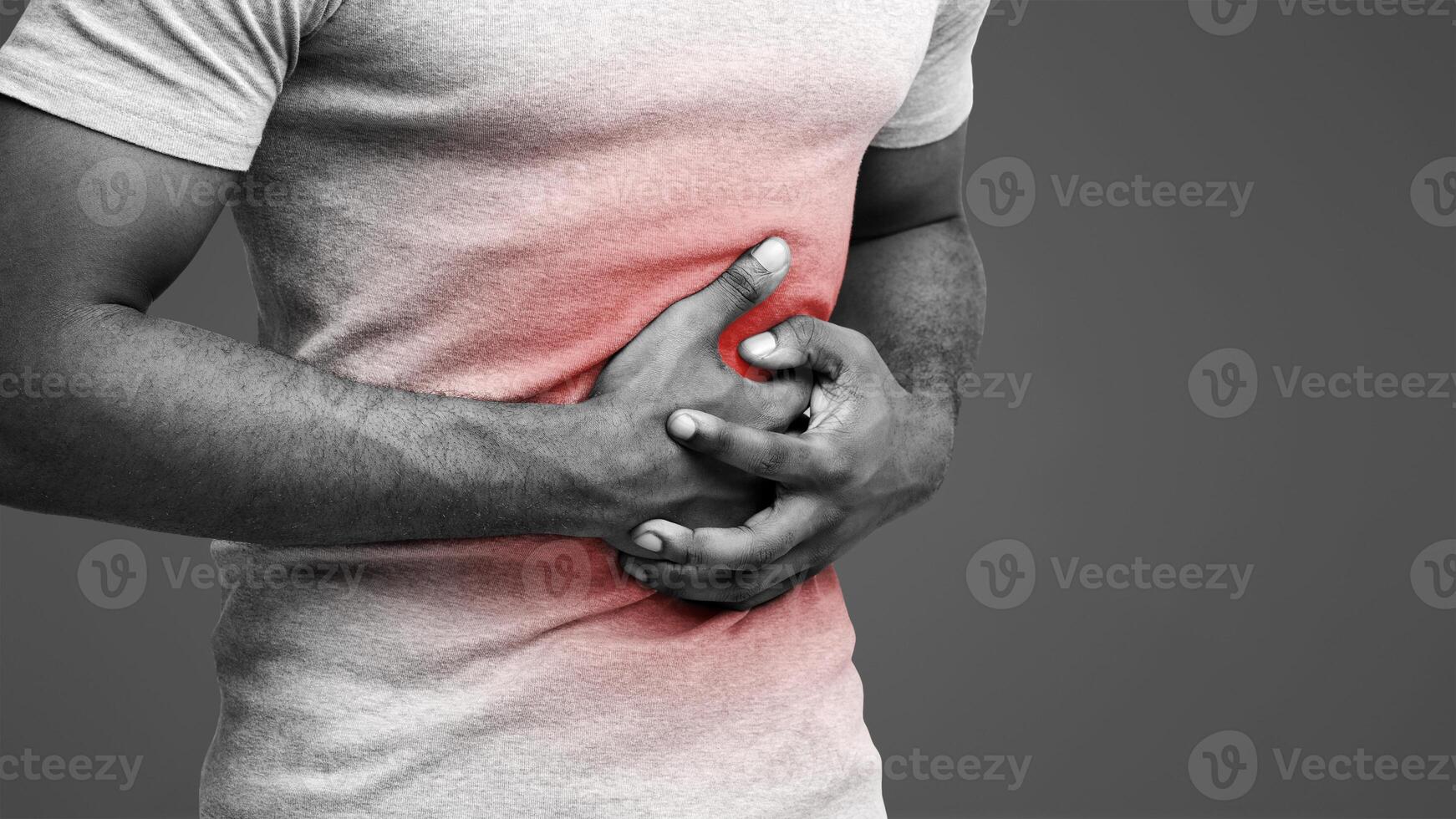 Food poisoning. Cropped of black man with abdominal pain, suffering from diarrhea, photo with red sore zone, copy space