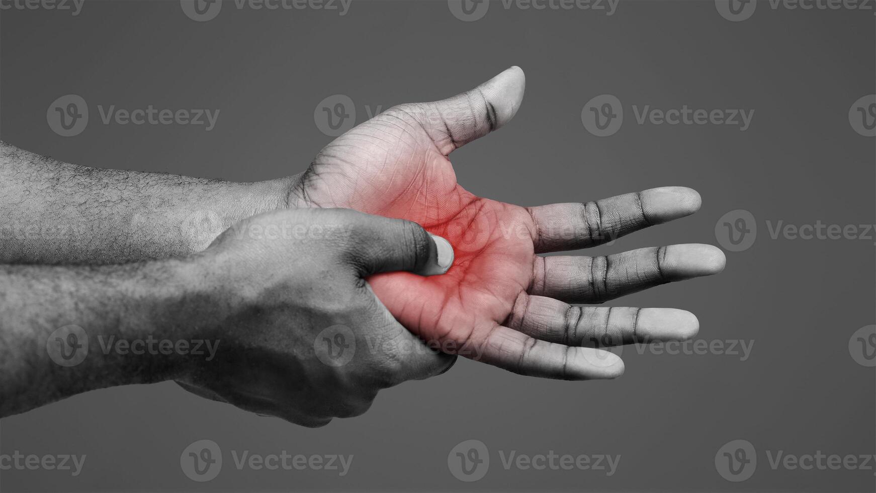 Pain in palm. Male hand suffering from work, afro man massaging sore zone, close up photo