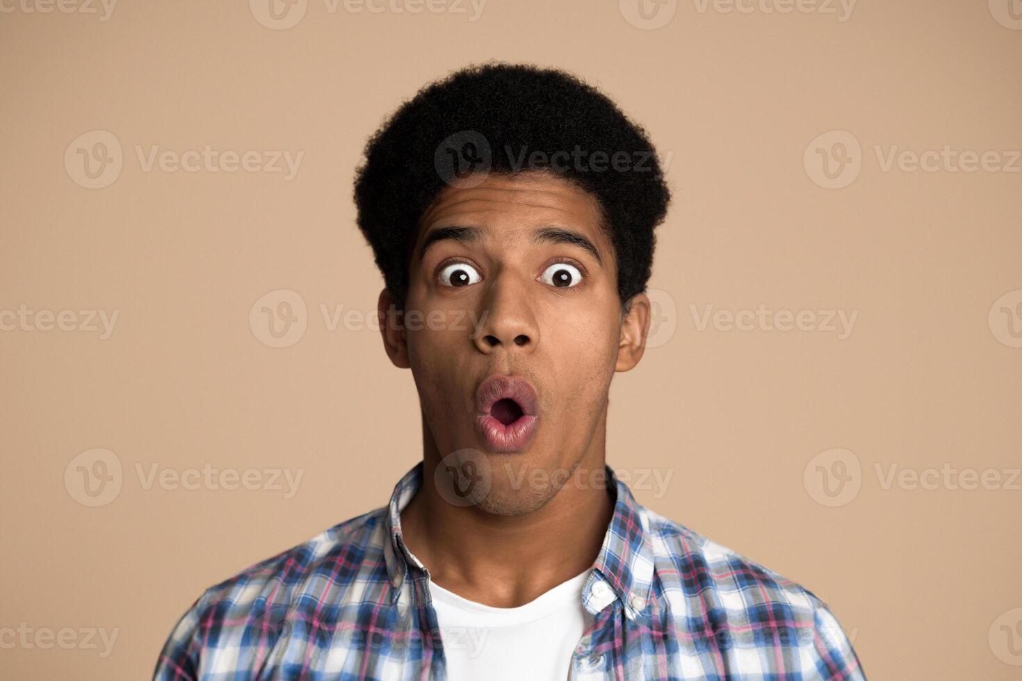 Omg. Shocked guy looking at camera over white studio background photo