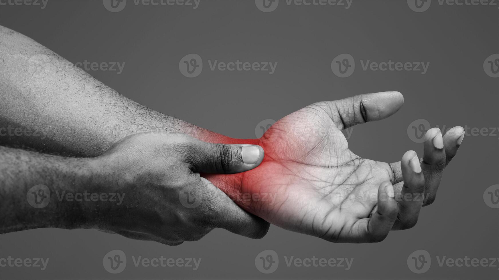 Close up of afro man rubbing his inflamed wrist, suffering from arthritis photo