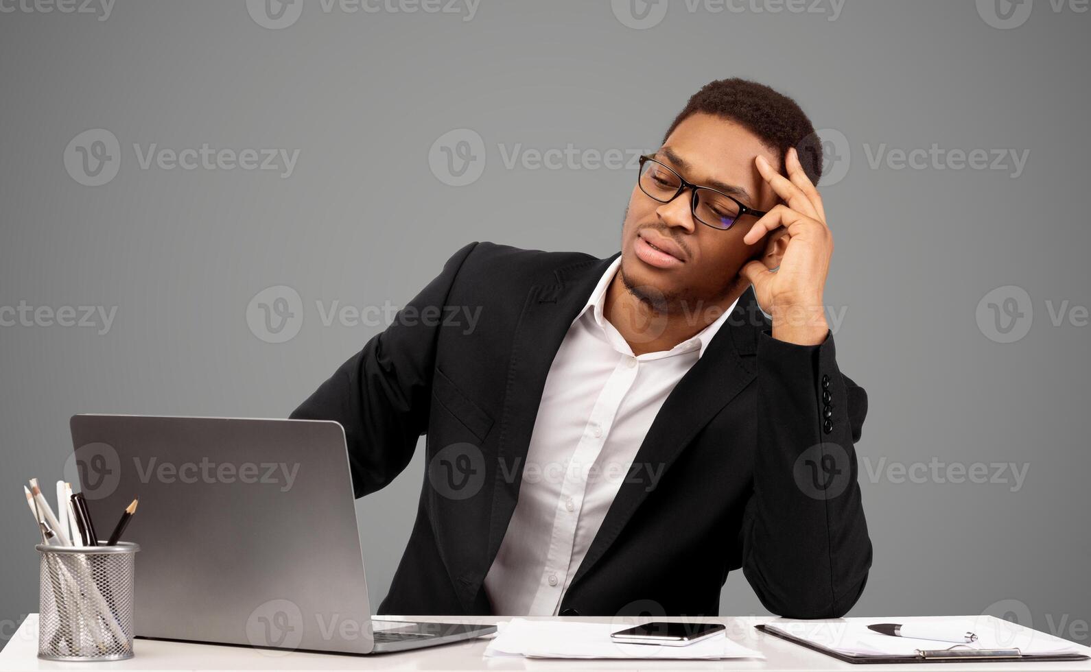 Problems At Work. Black businessman feeling upset and desperate, looking at computer, working at office. Free space photo