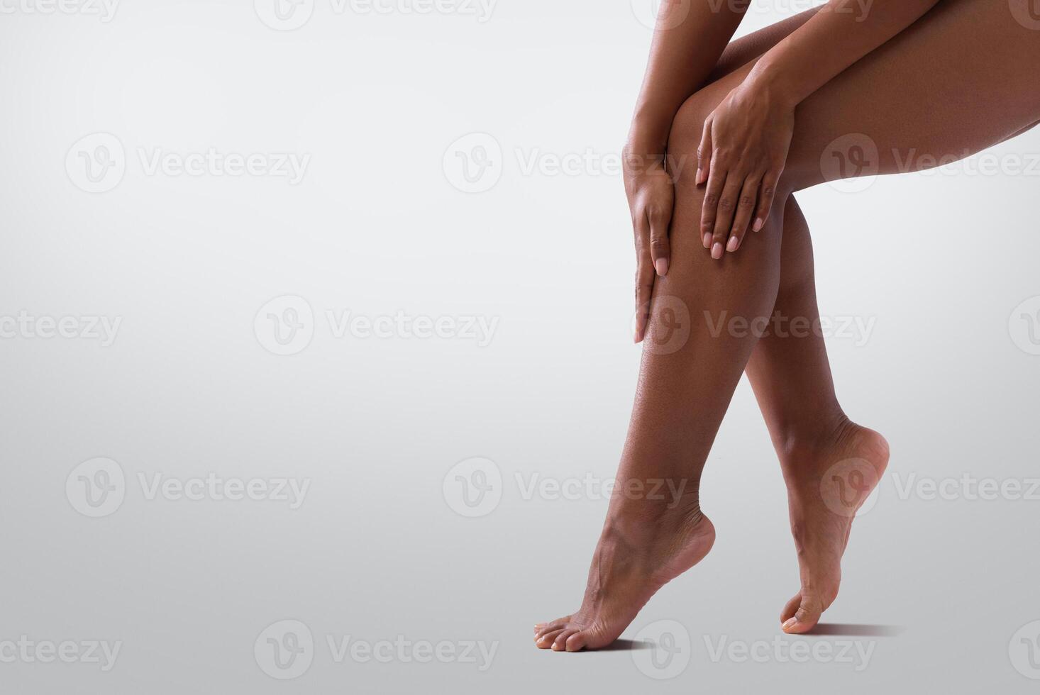 Cropped of female legs, black woman touching her skin after waxing or epilation, copy space photo