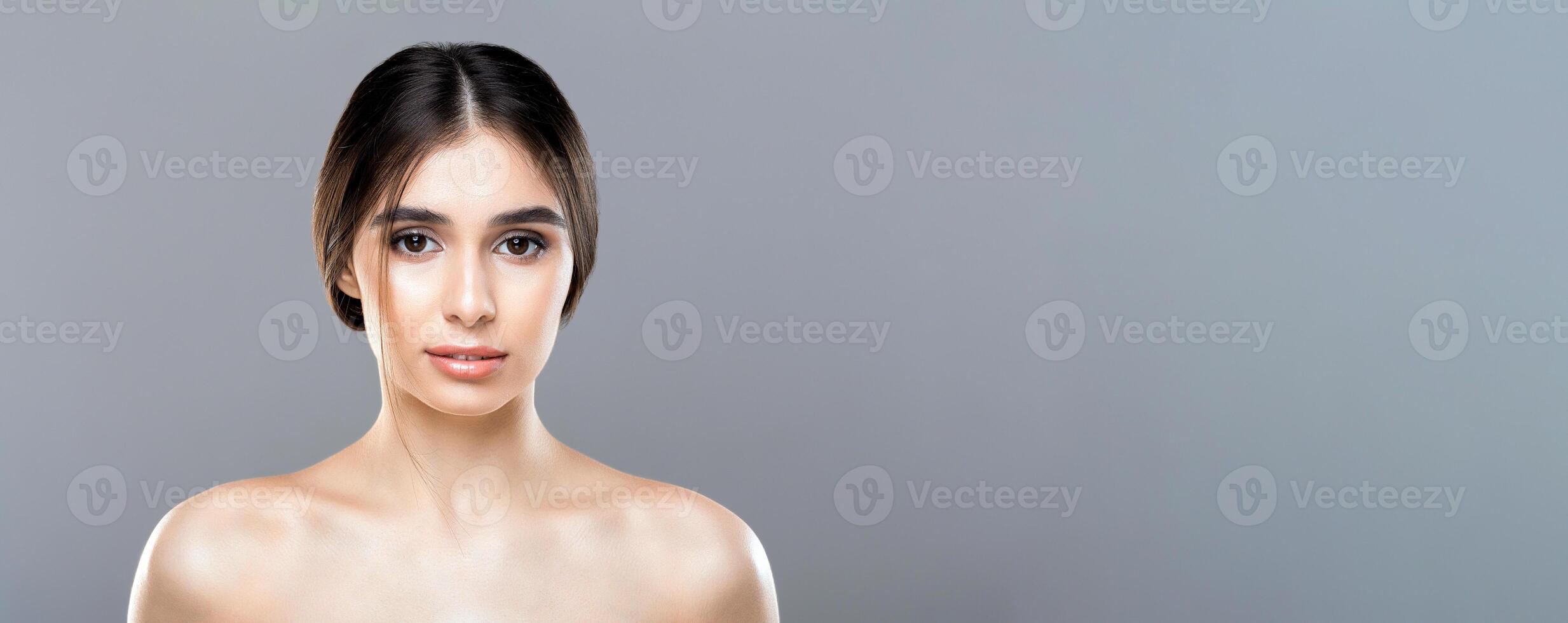 A woman without a shirt on is striking a pose while being photographed. She is confidently showcasing her figure in a bold manner, copy space, web-banner photo