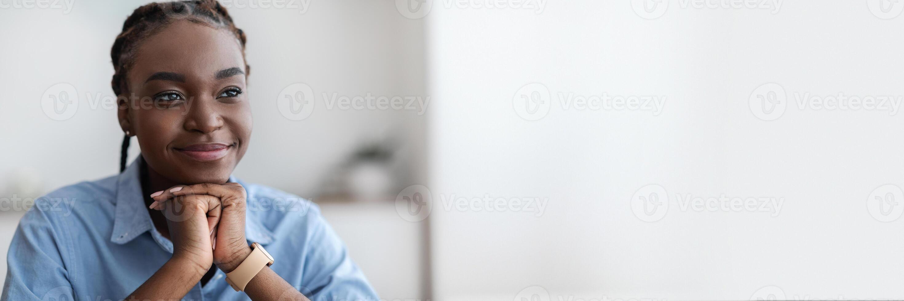 Closeup Portrait Of Dreamy Young Black Woman With Braids Looking Away, Resting Chin On Hands, Thoughtful Millennial African American Lady Daydreaming At Workplace In Office, Free Space photo