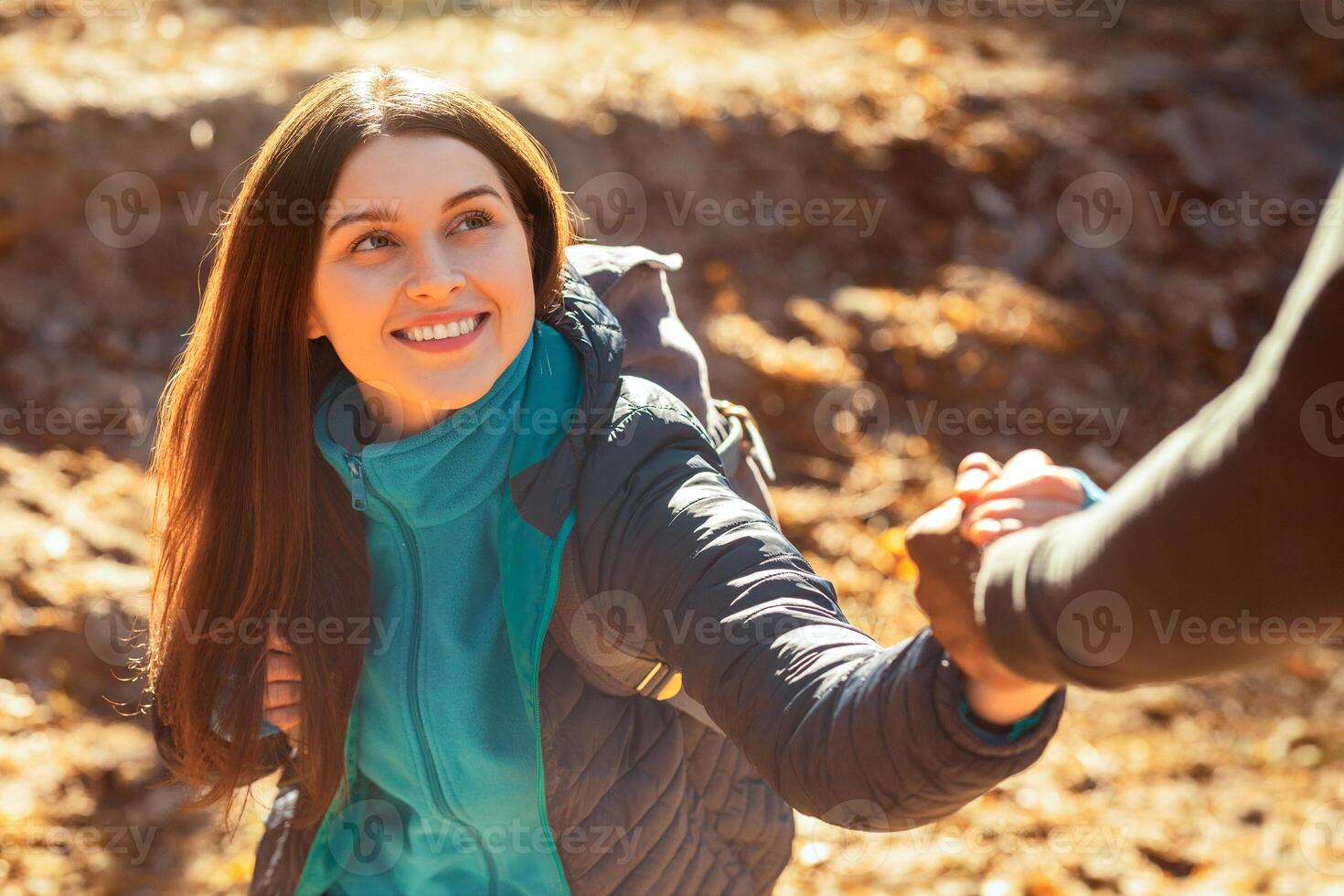Portrait of pretty cheerful girl supported by man while hiking, close up photo