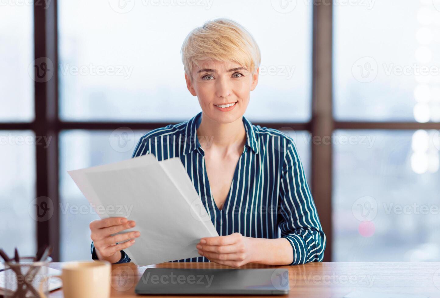 Business Career And Employment. Businesswoman Employer Holding Papers And Documents Smiling To Camera Sitting In Modern Office. Selective Focus photo