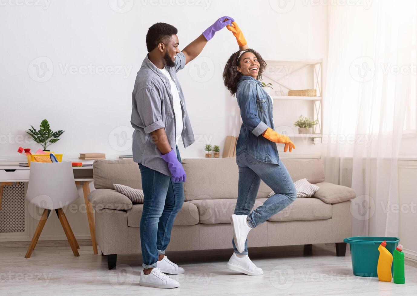 Loving African American Couple Dancing While Cleaning Flat Together, Having Fun At Home, Copy Space photo