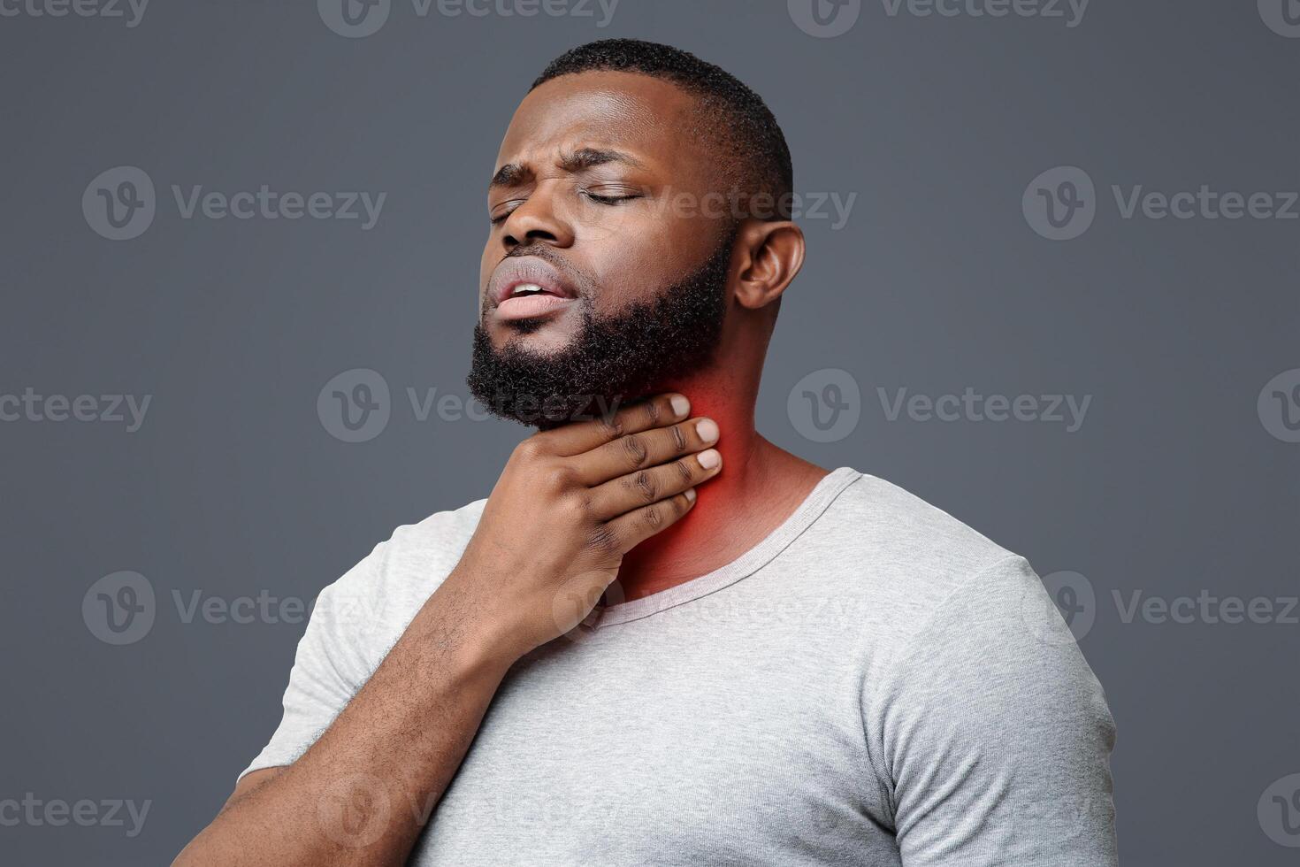 Sad black guy suffering from sore throat, touching highlighted neck, copy space photo