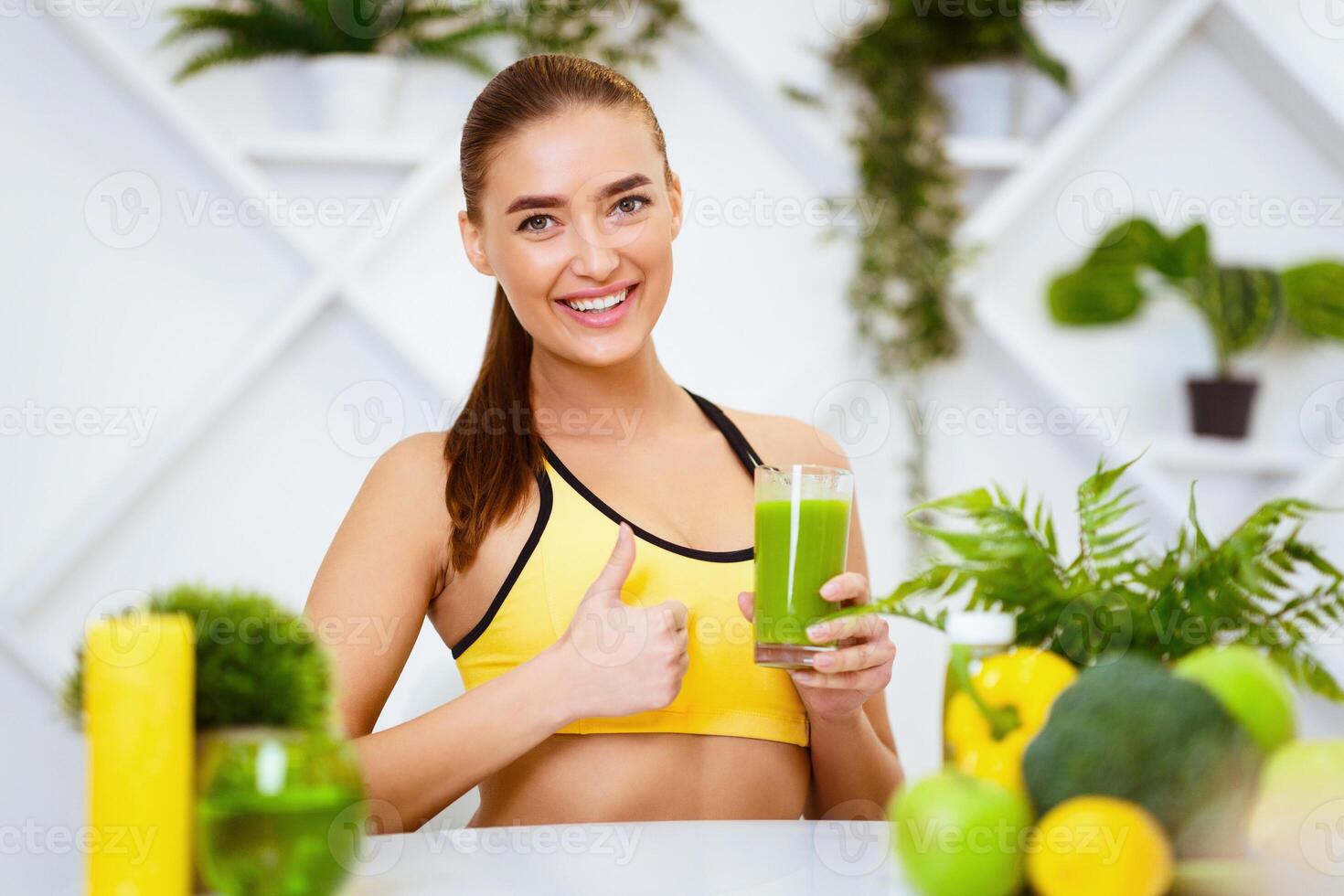 Fit Girl Recommending Healthy Smoothie, Showing Thumb Up In Kitchen photo