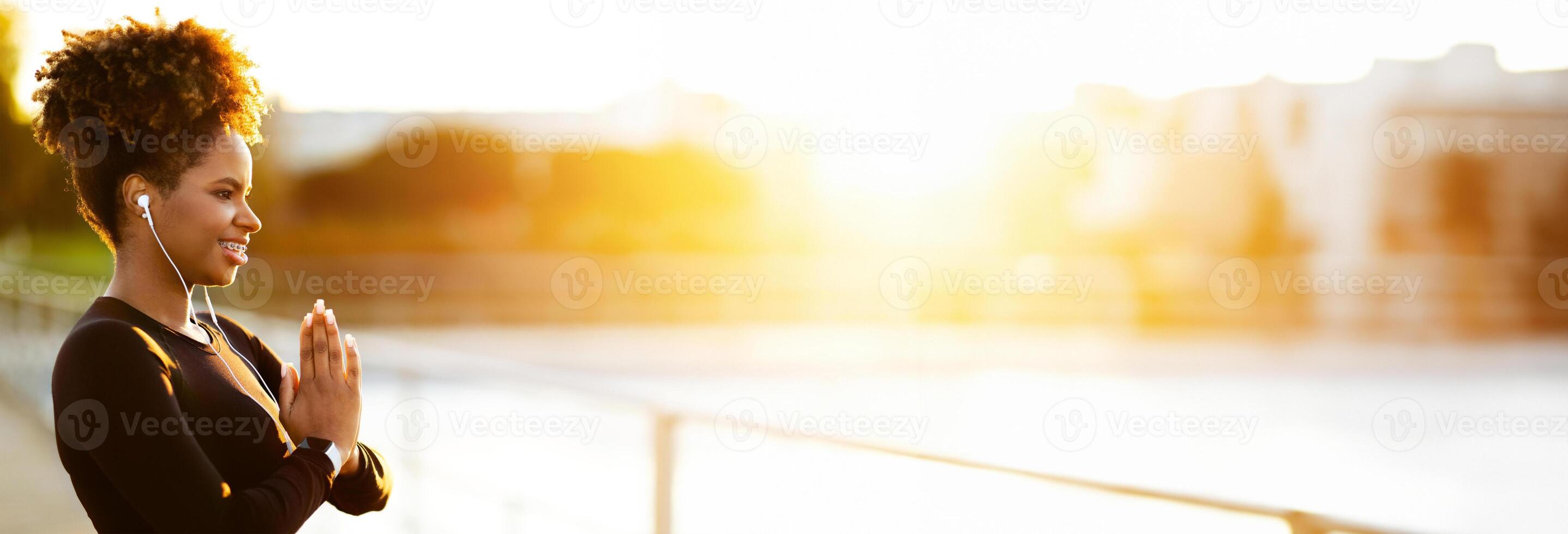 Wellness Concept. Portrait Of Relaxed Black Sporty Woman Meditating Outdoors, Calm African American Lady In Activewear Making Namaste Gesture With Clasped Hands, Enjoying Outside Trainings, Copy Space photo