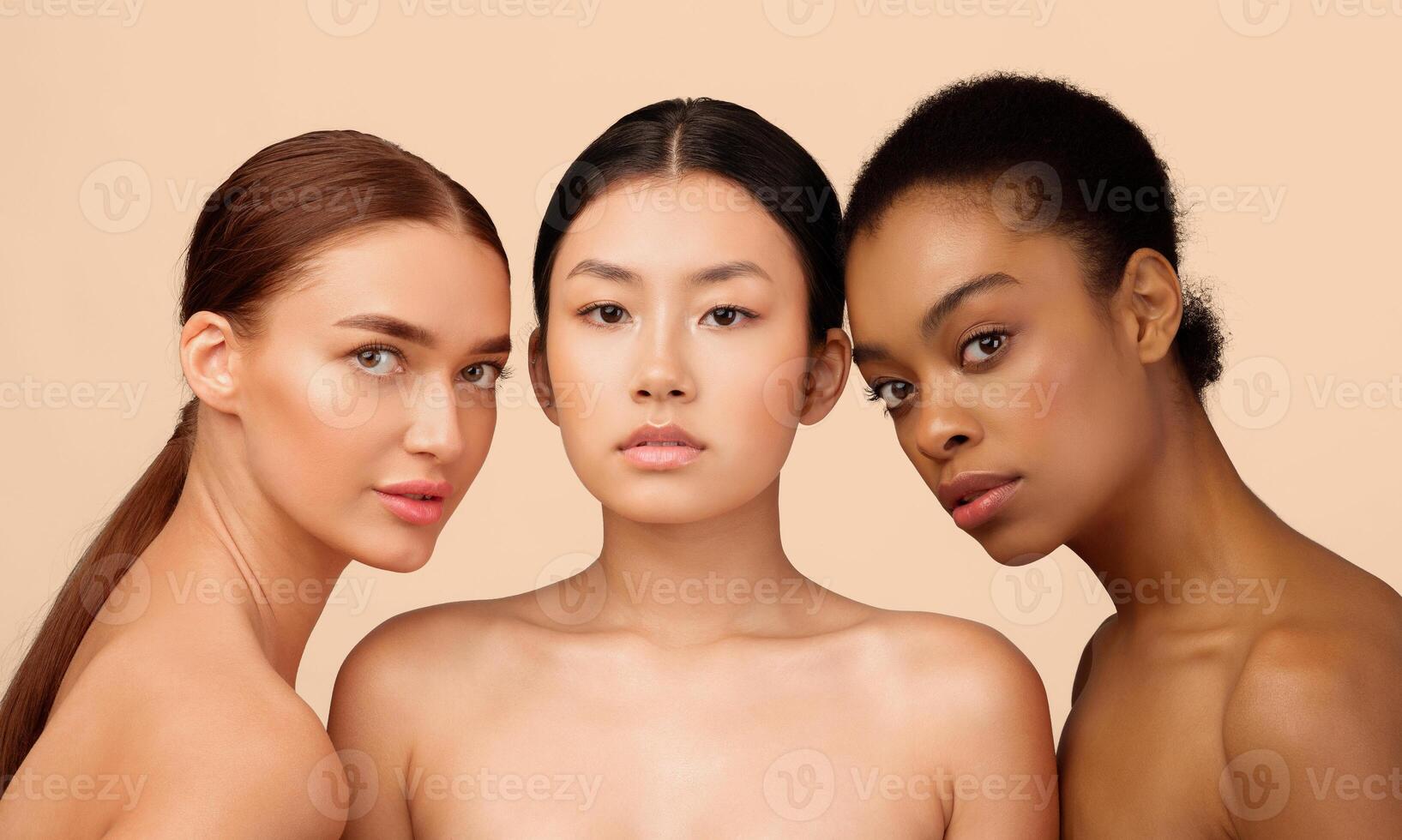 Three Sensual Diverse Models Girls Posing Naked Looking At Camera Over White Studio Background. Multiethnic Beauty Portrait. photo