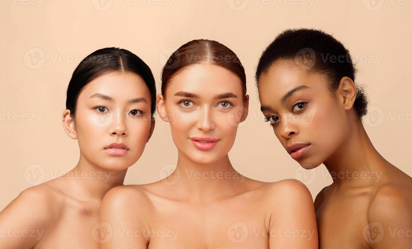 Female Beauty. Three Multiracial Models Girls Looking At Camera Posing Naked On White Background In Studio photo
