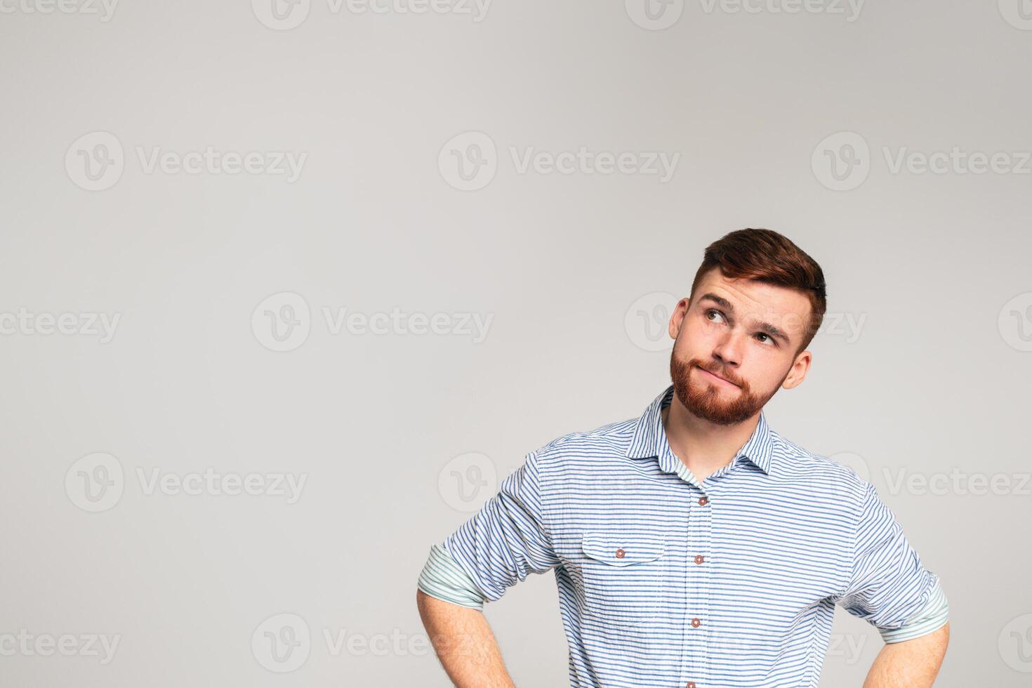 Thoughtful man looking away at copy space on studio background, panorama photo