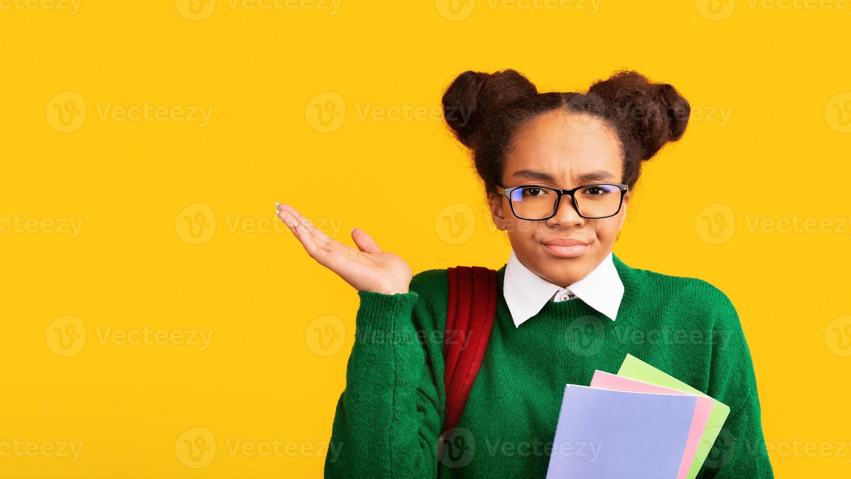 I Hate School. Unhappy black girl spreading hands over yellow background, panorama, free space photo