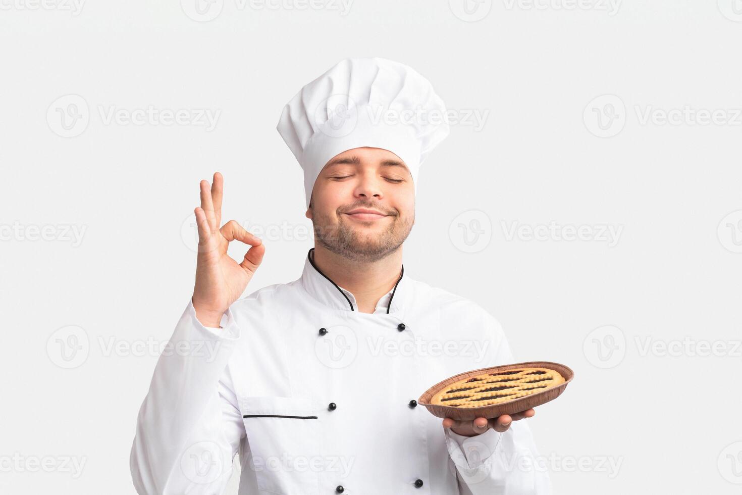 Cheerful Chef Man Showing Baked Pie Standing Over White Studio Background. Easy Culinary Recipes. Panorama photo
