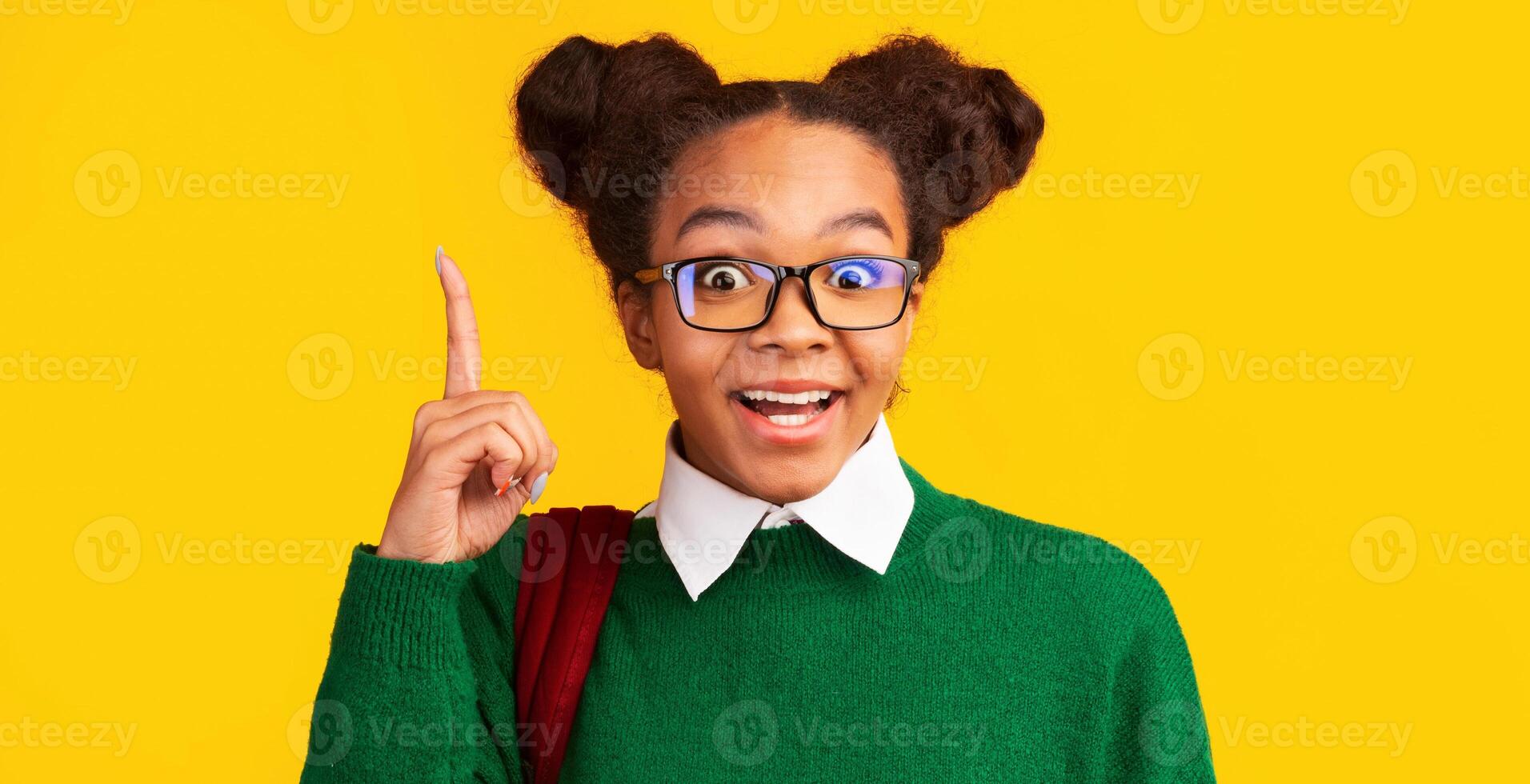 Aha Moment. Headshot of excited black girl with opened mouth pointing finger up at studio, copyspace, panorama photo
