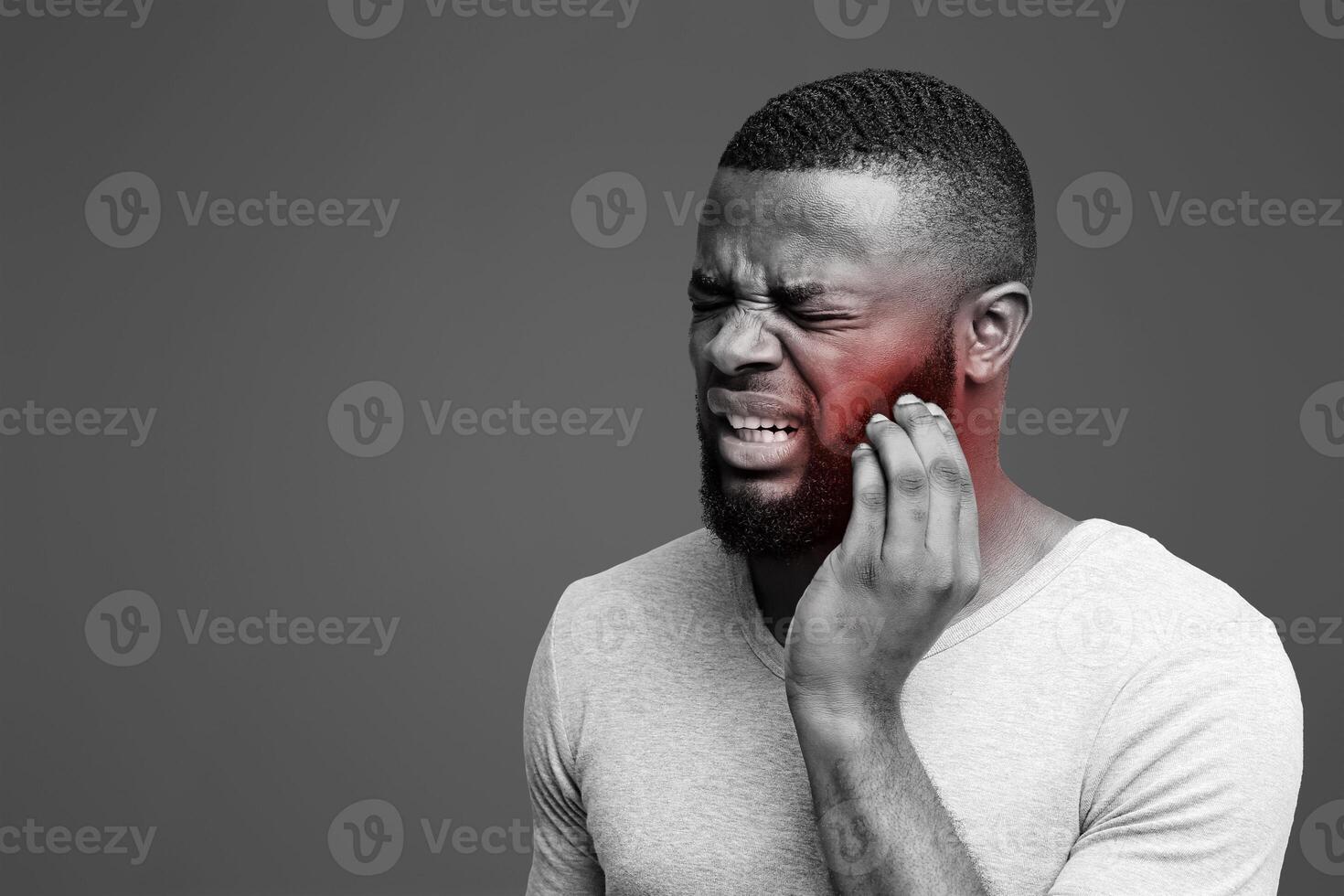 Young black man having wisdom teeth problem, suffering from acute toothache photo