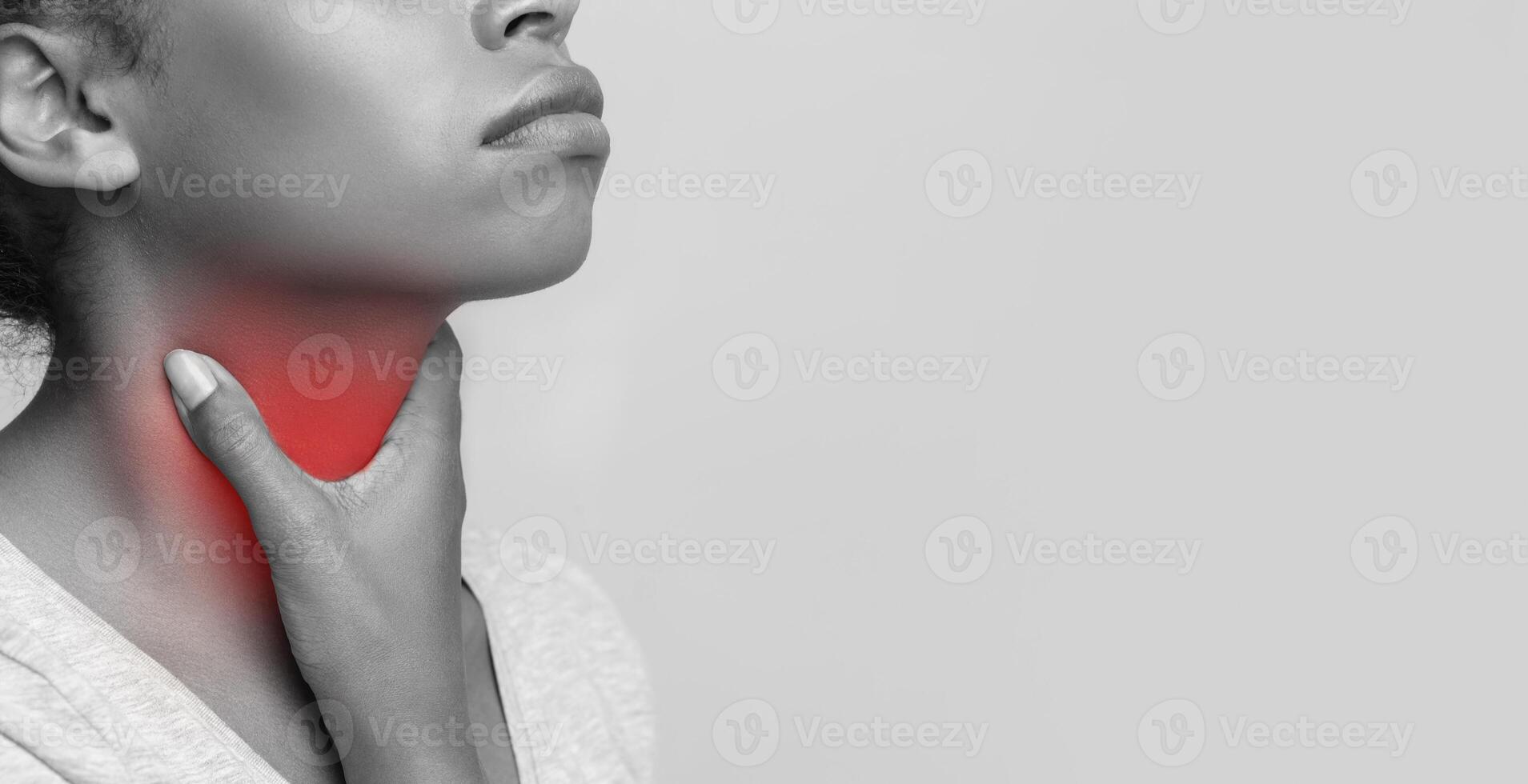 Monochrome photo of african woman suffering from tonsillitis, touching her highlighted with red throat, cropped, free space