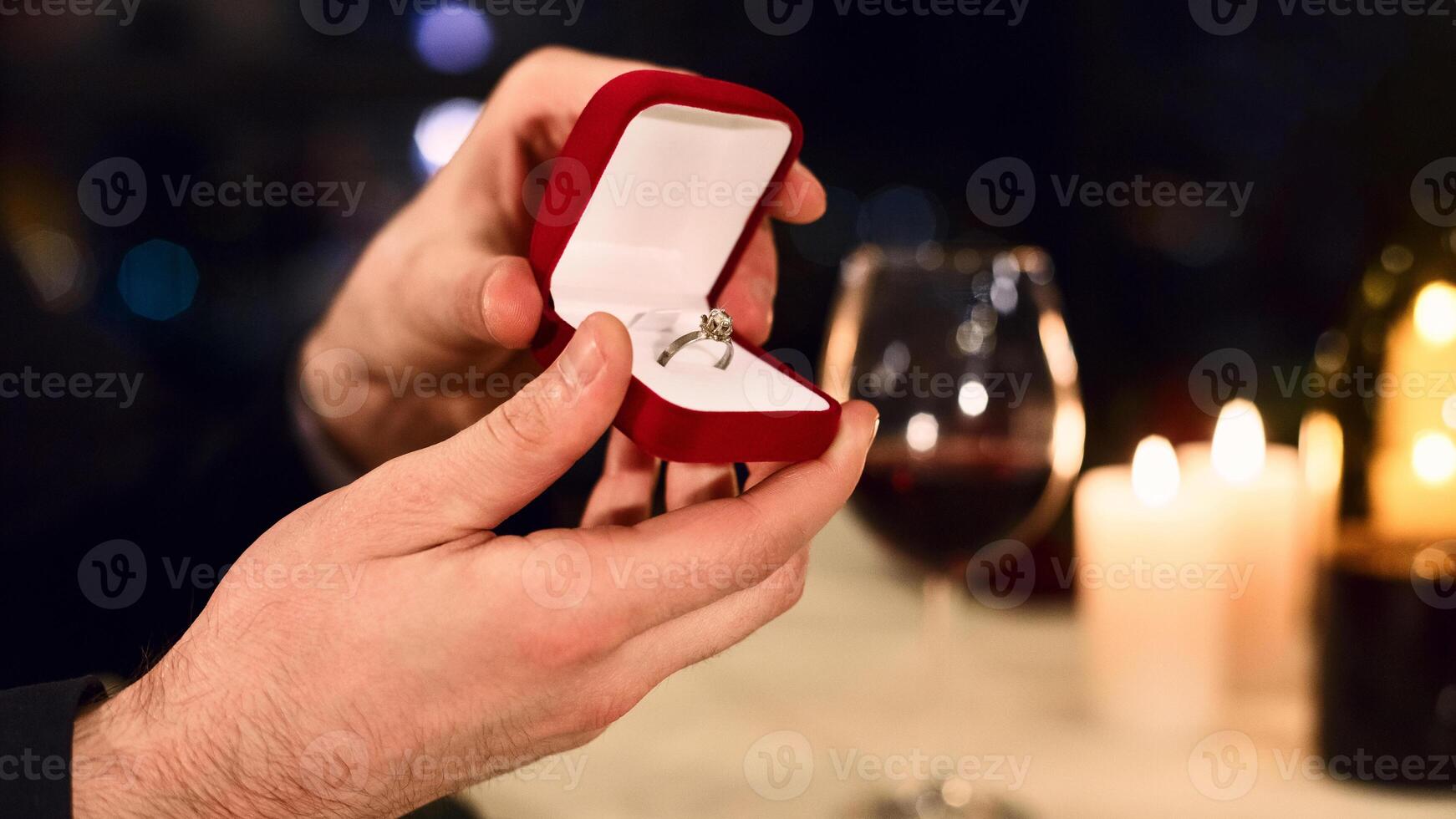 Man's hands holding box with diamond ring, lover making proposal, cropped, copy space. Marry me concept photo