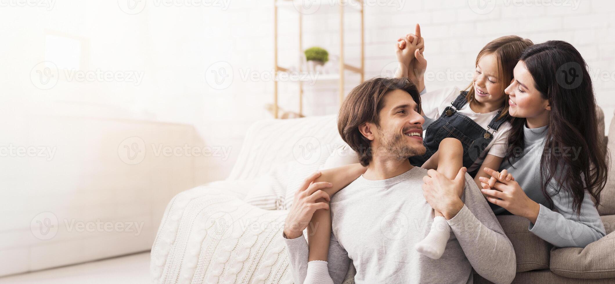 Happy family at home playing together in living room photo