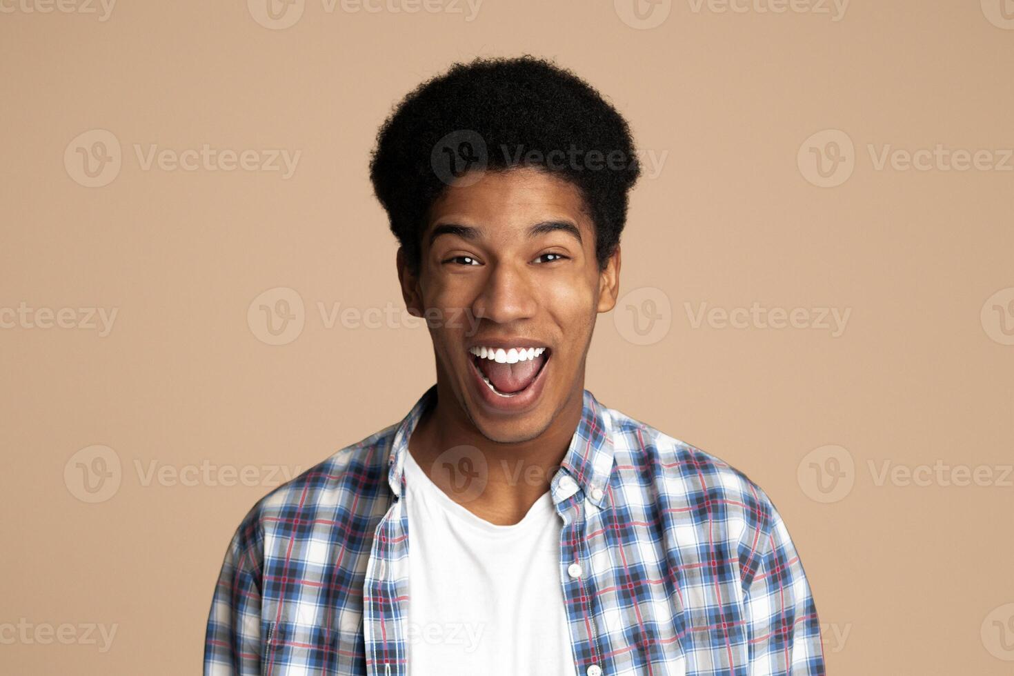 Excited man expressing great surprisment over light studio background photo