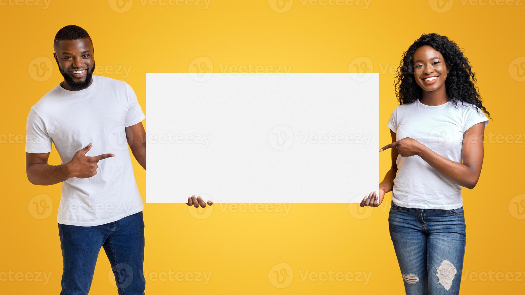Black Smiling Man And Woman Pointing at White Blank Card With Empty Space photo