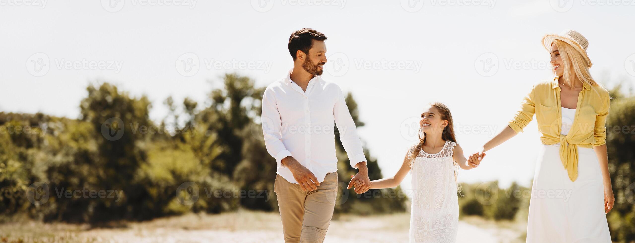 Family walk. Happy family resting in countryside and having fun, talking and laughing photo